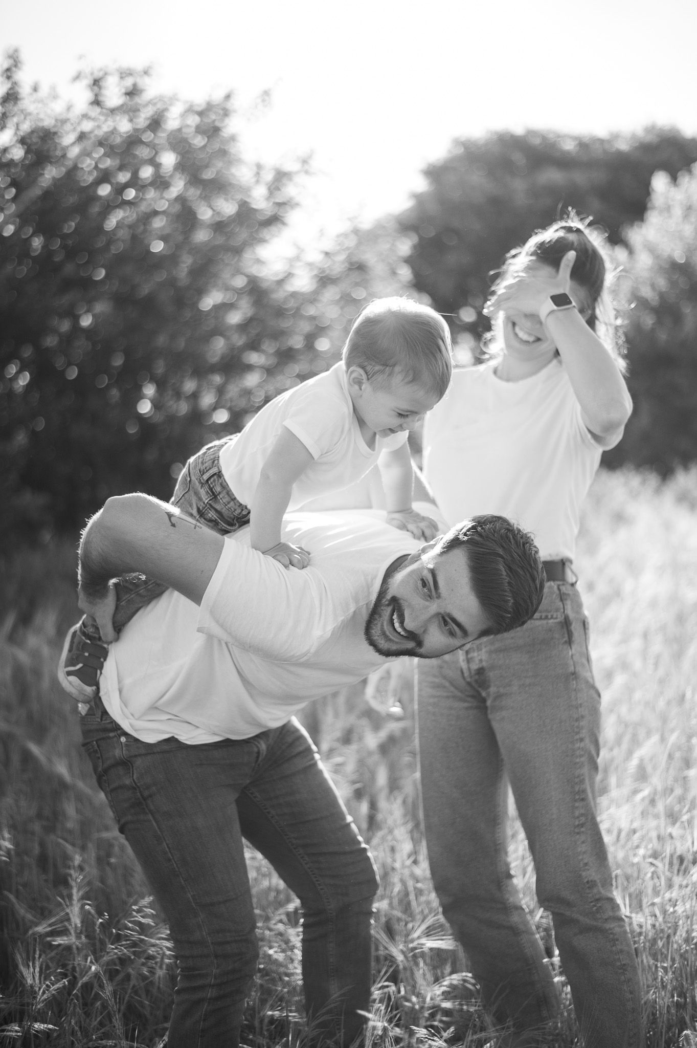 Black and white sequence showing joyful interaction in a sunlit field.