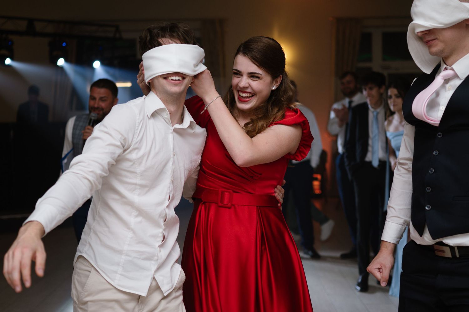Wedding party dancing and celebrating in formal attire.