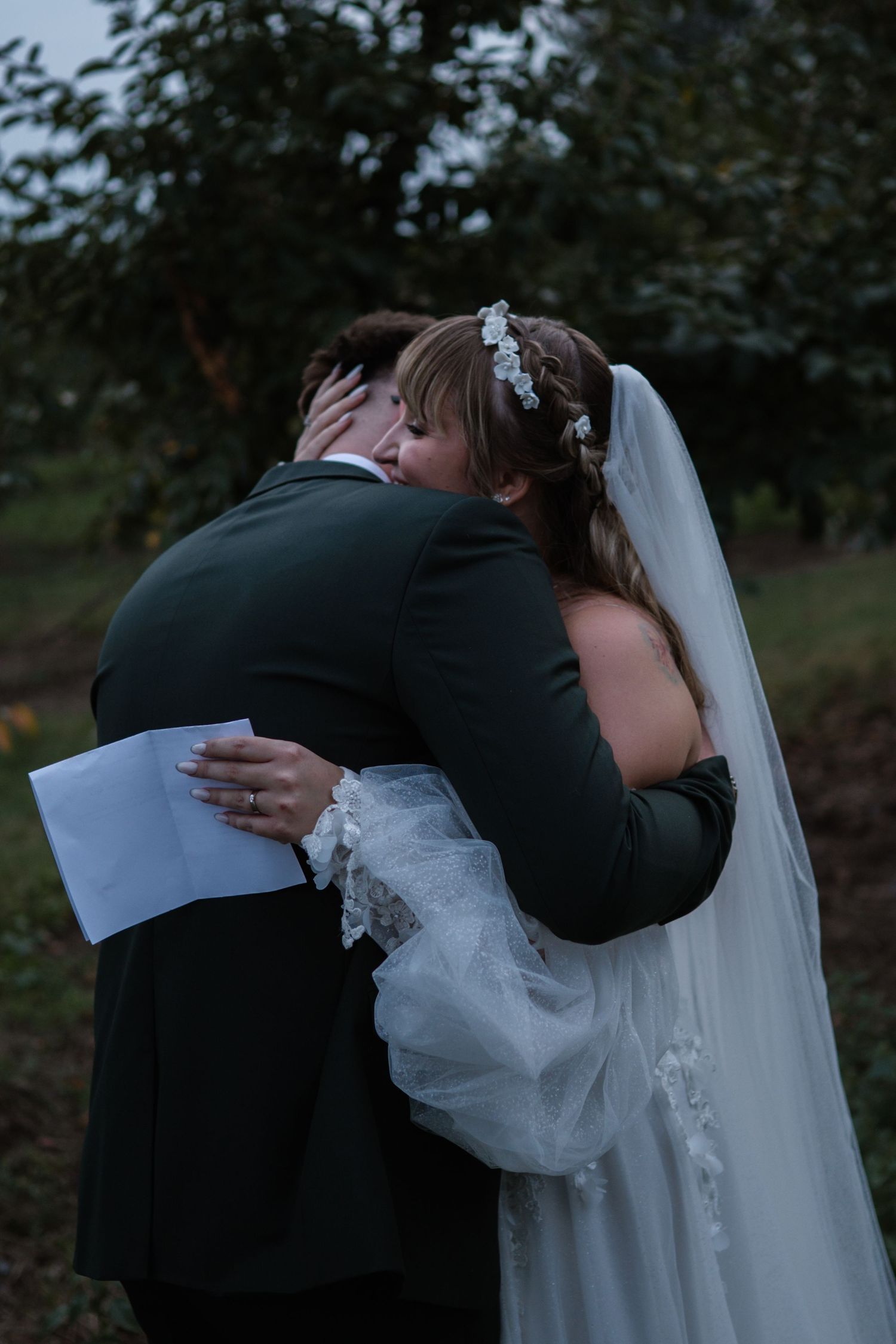 Emotional wedding moments shared between couple reading personal vows.