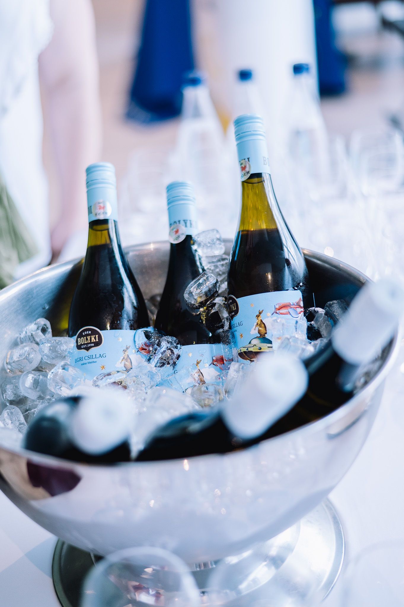 Wine bottles chilling in ice bucket at upscale event.