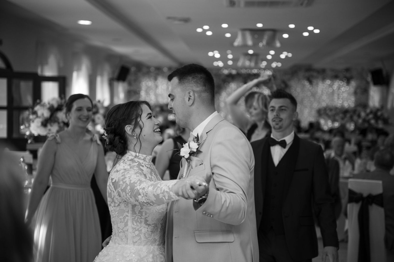 Wedding reception dance floor with guests celebrating in an elegant ballroom.