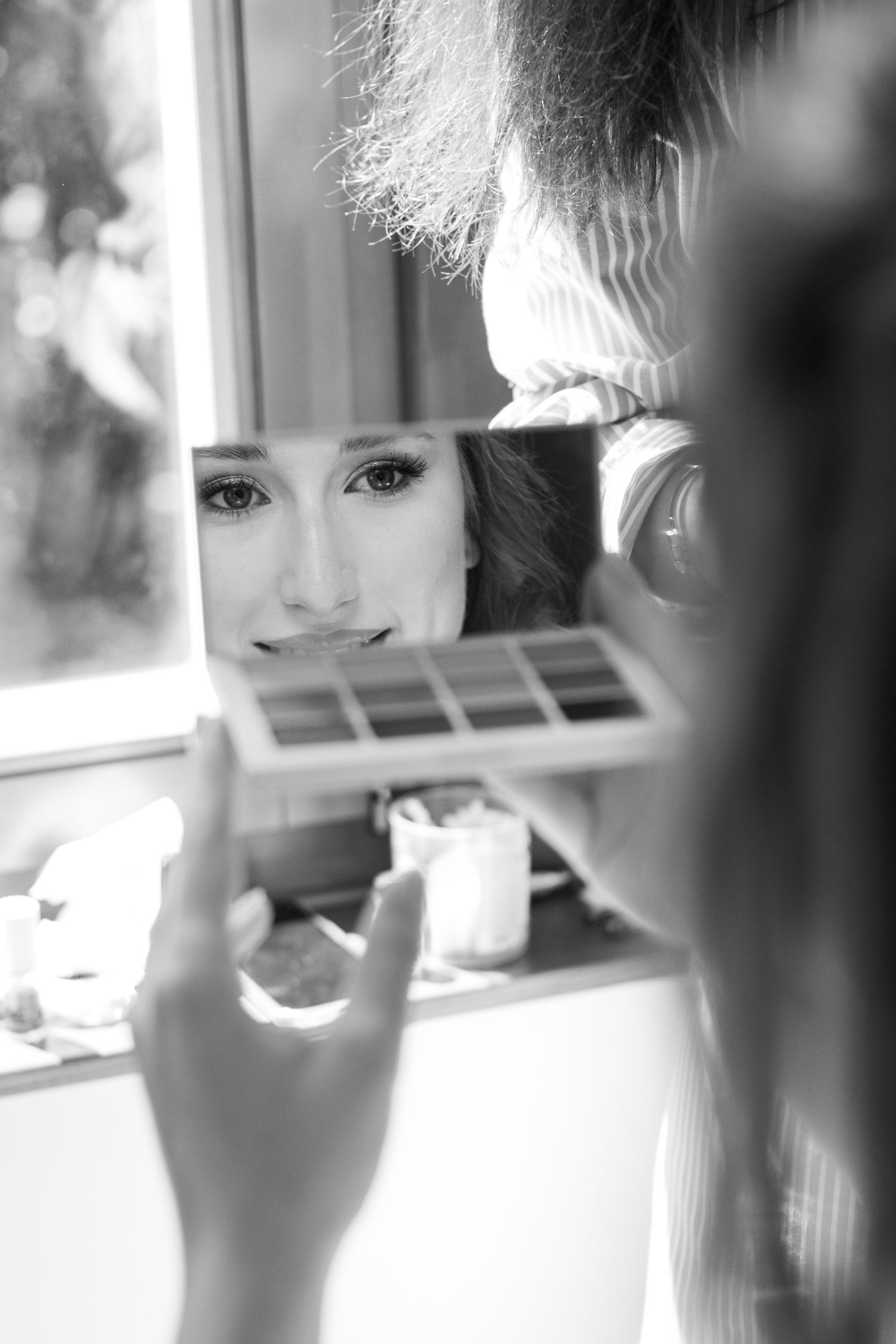 Wedding preparation scene with soft natural window lighting.