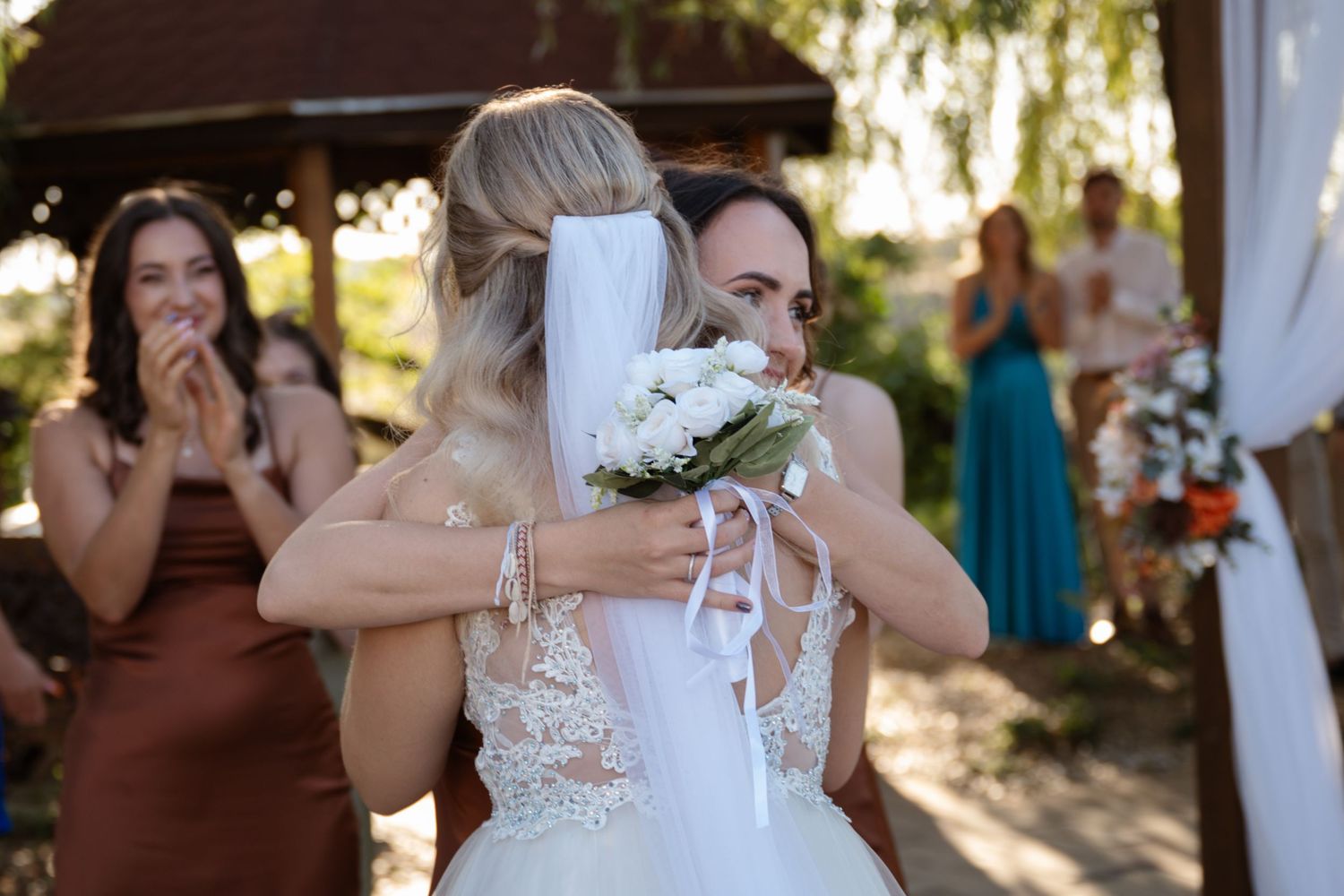 Wedding party celebrates with champagne toasts during an outdoor reception.