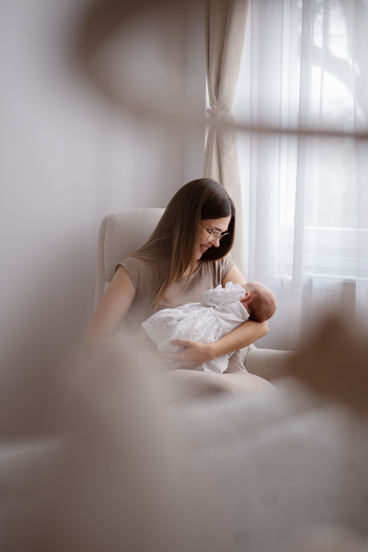 Soft focus artistic series of someone in white lying on bed near window with dreamy ethereal lighting.