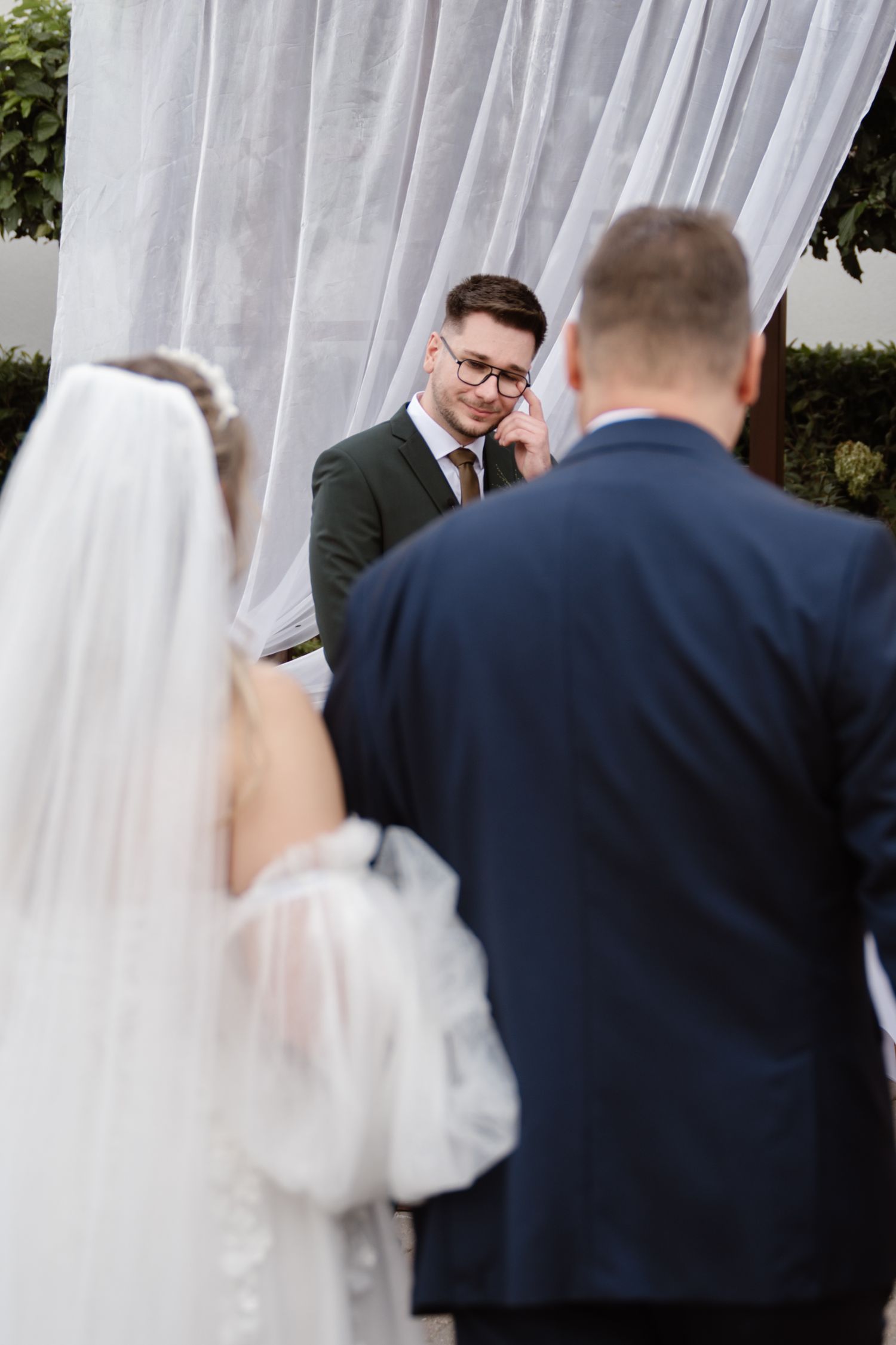Close-up shots of a wedding couple walking together outdoors.