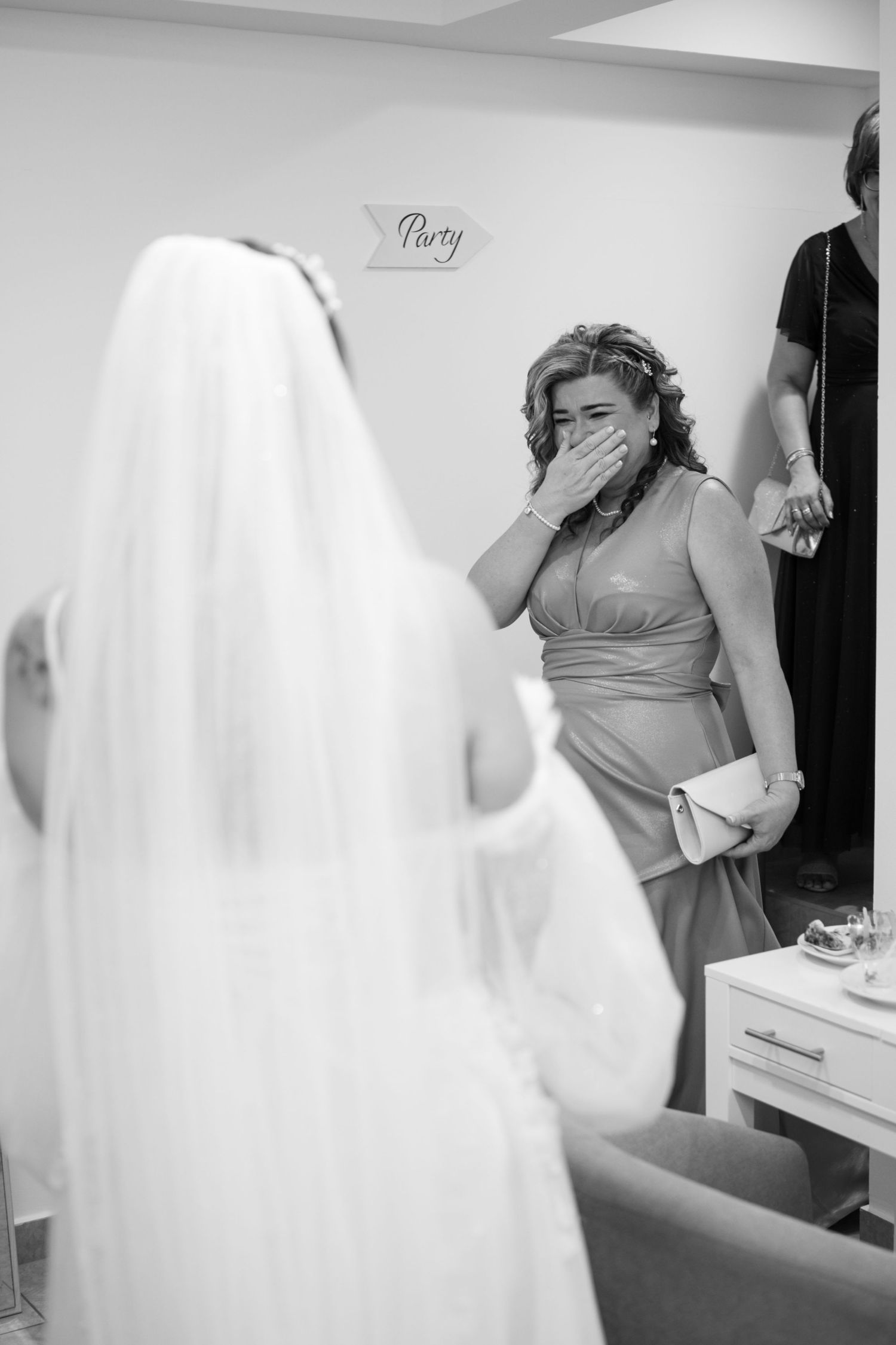 Emotional first look reaction during a wedding as someone covers their mouth in surprise.