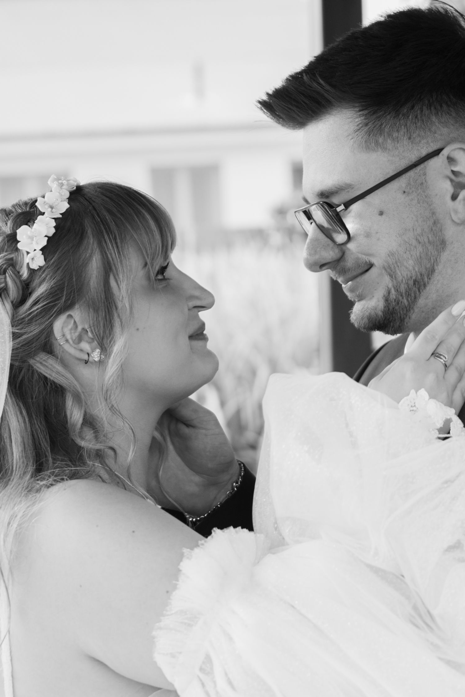 Romantic black and white close-up shots of newlyweds sharing tender moments.