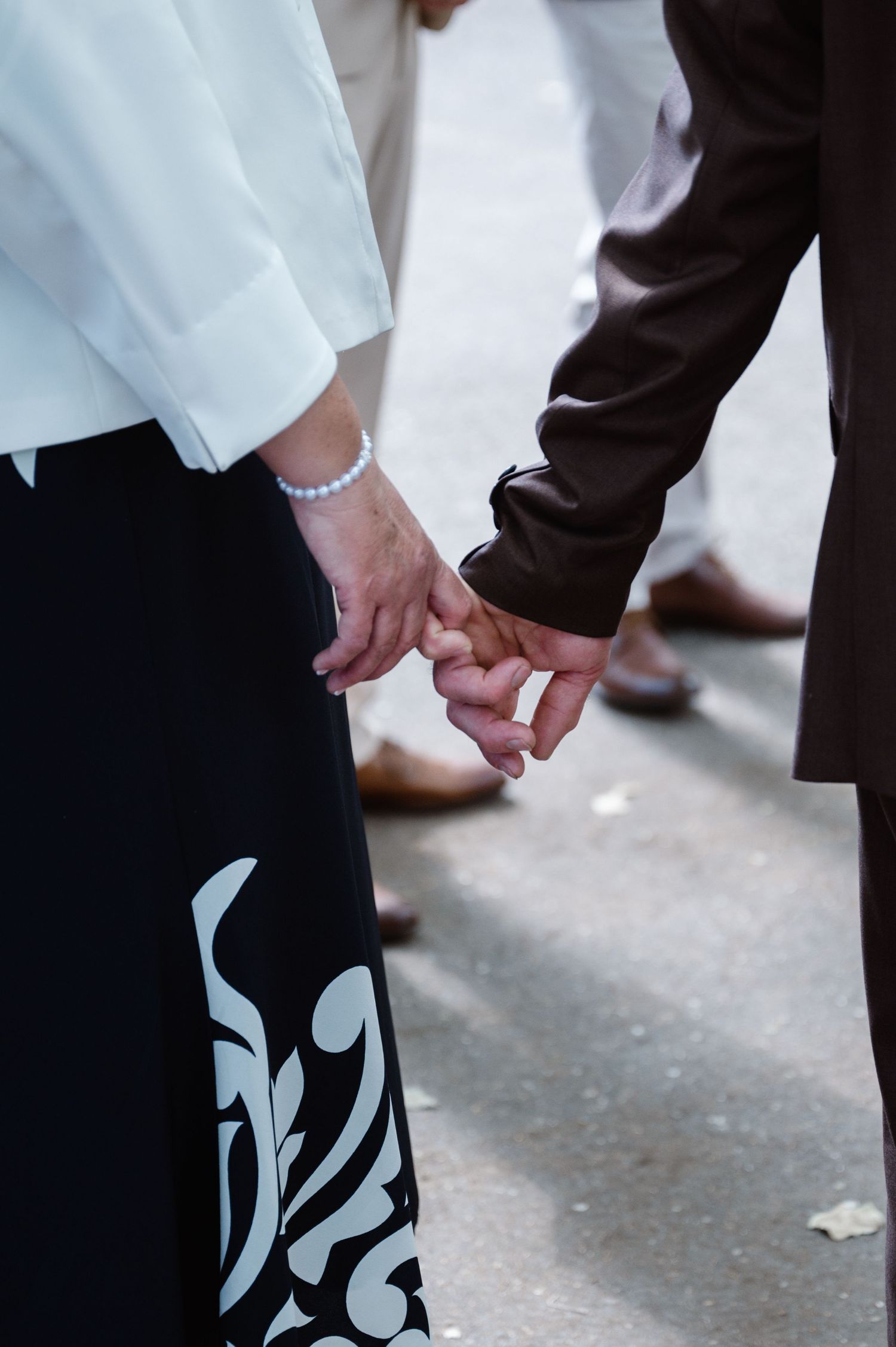 Close-up of formal attire showing decorative pattern detail on clothing.