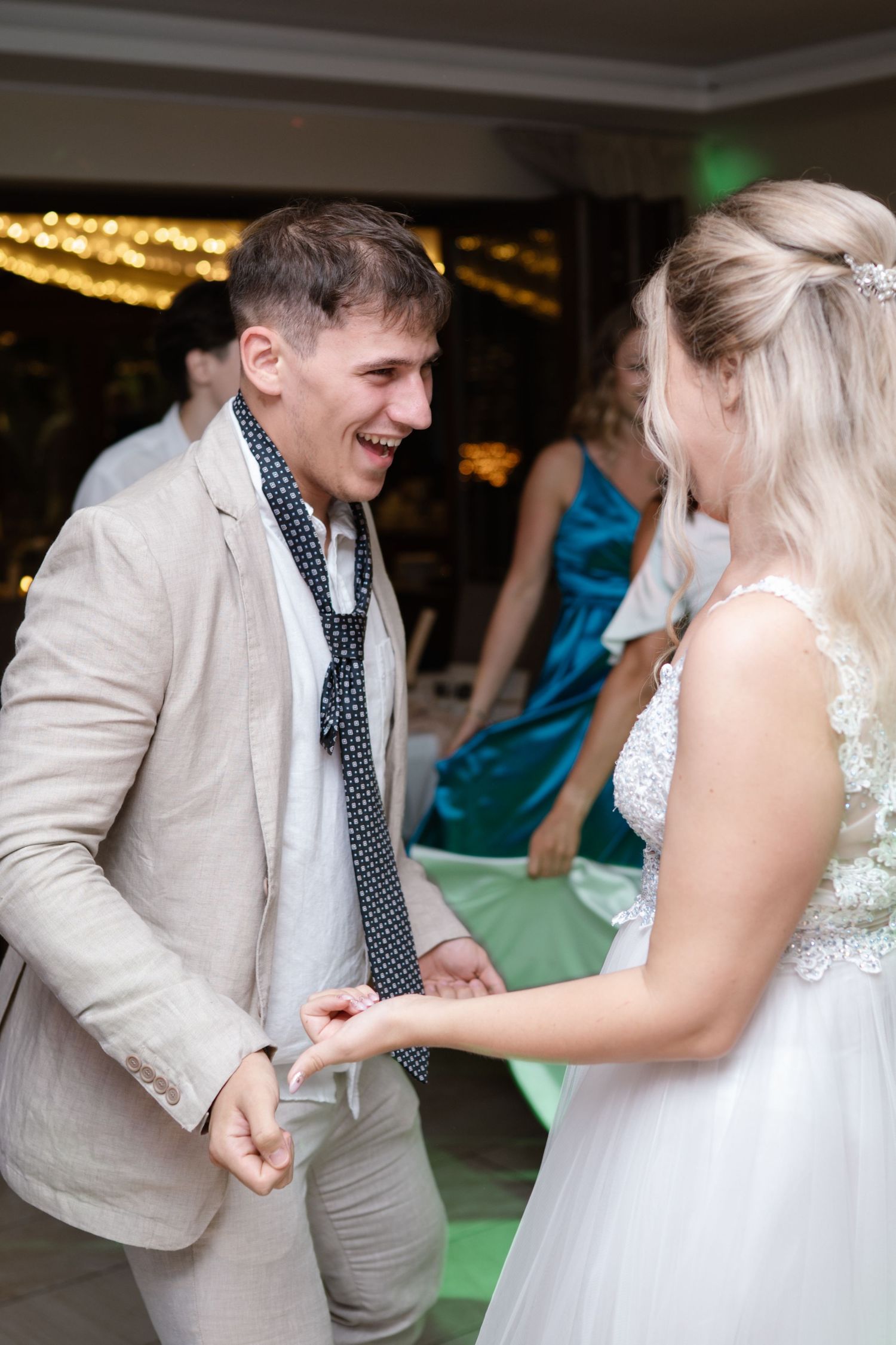 Newlyweds share a playful dance moment at their wedding reception.