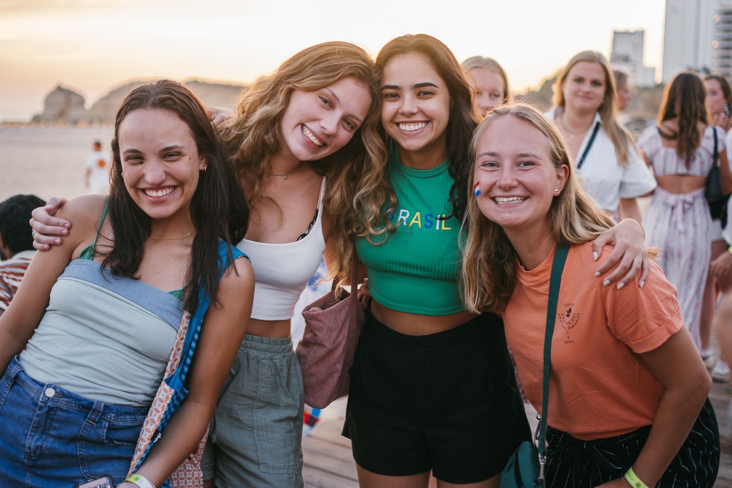 Friends posing together for a casual group photo at sunset.