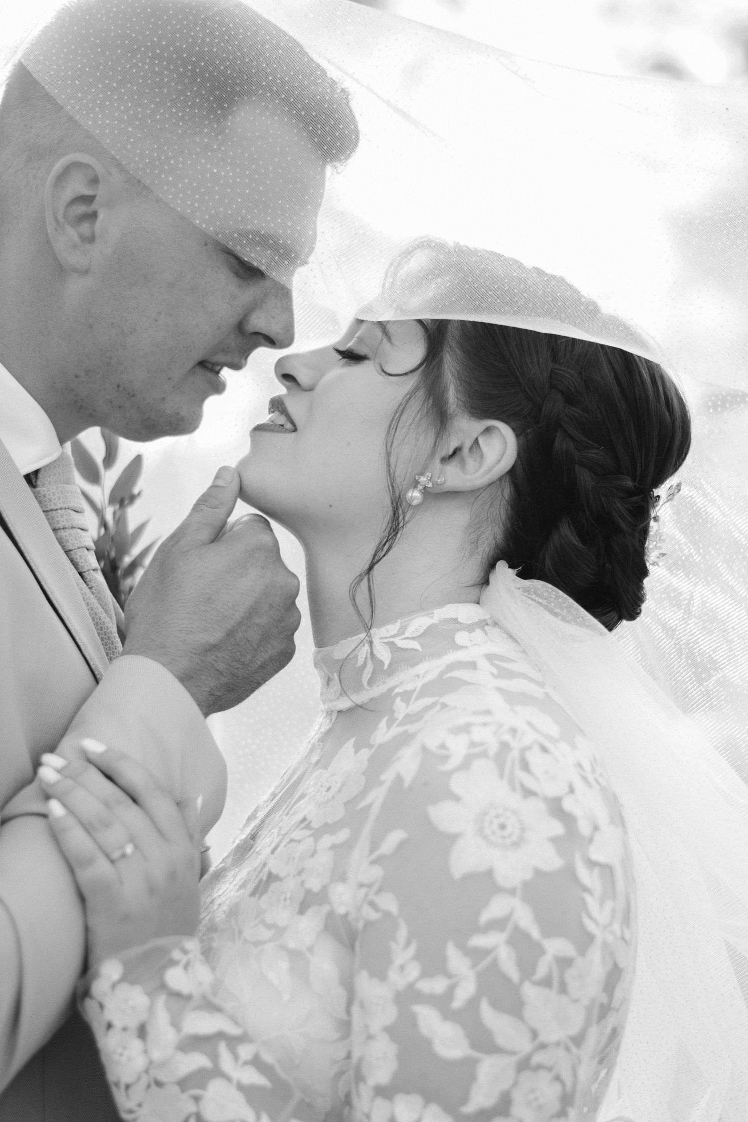 Close-up romantic black and white wedding portraits showing tender moments between newlyweds.