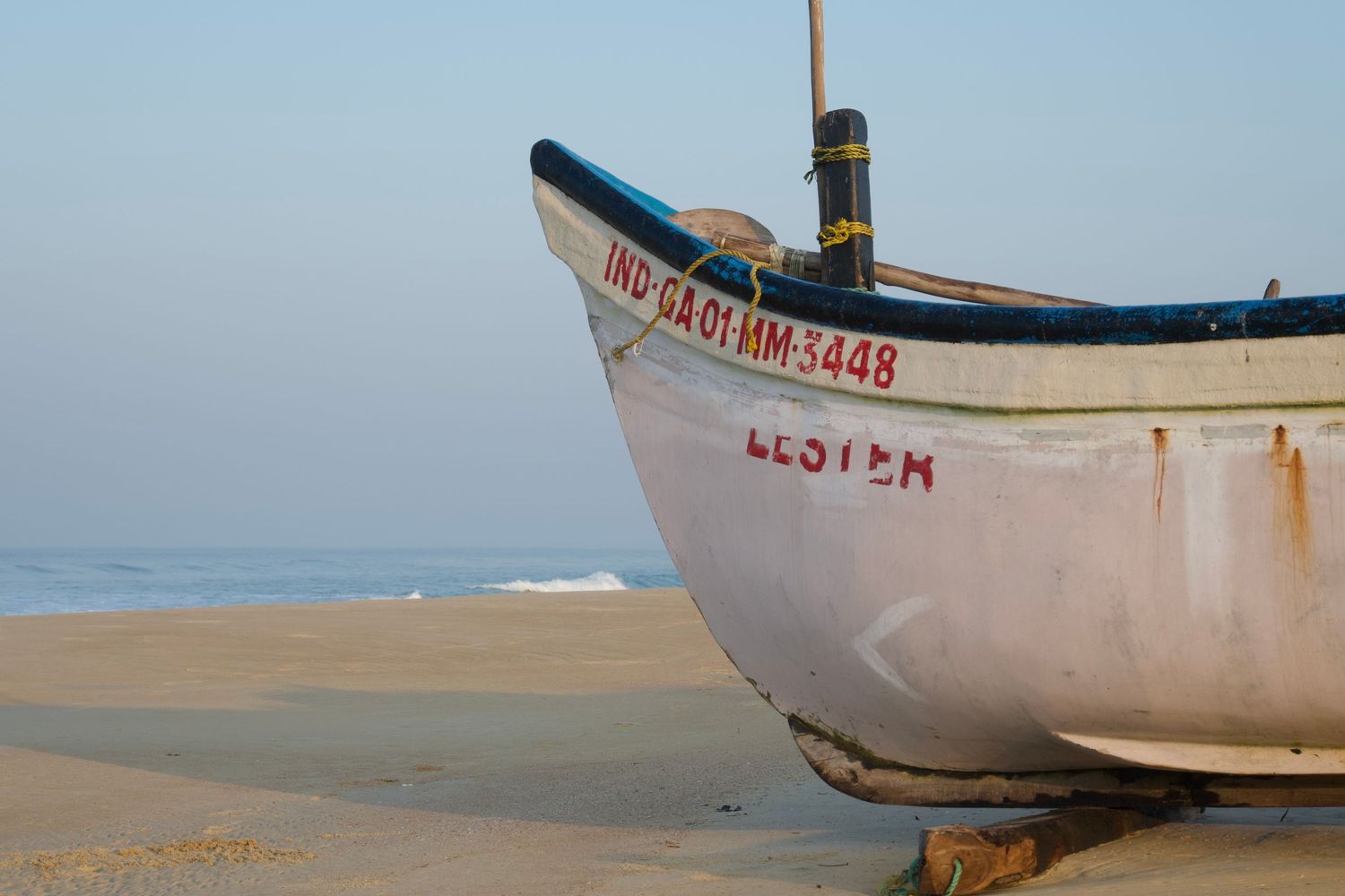 Abandoned boat on a beach in Goa, India.