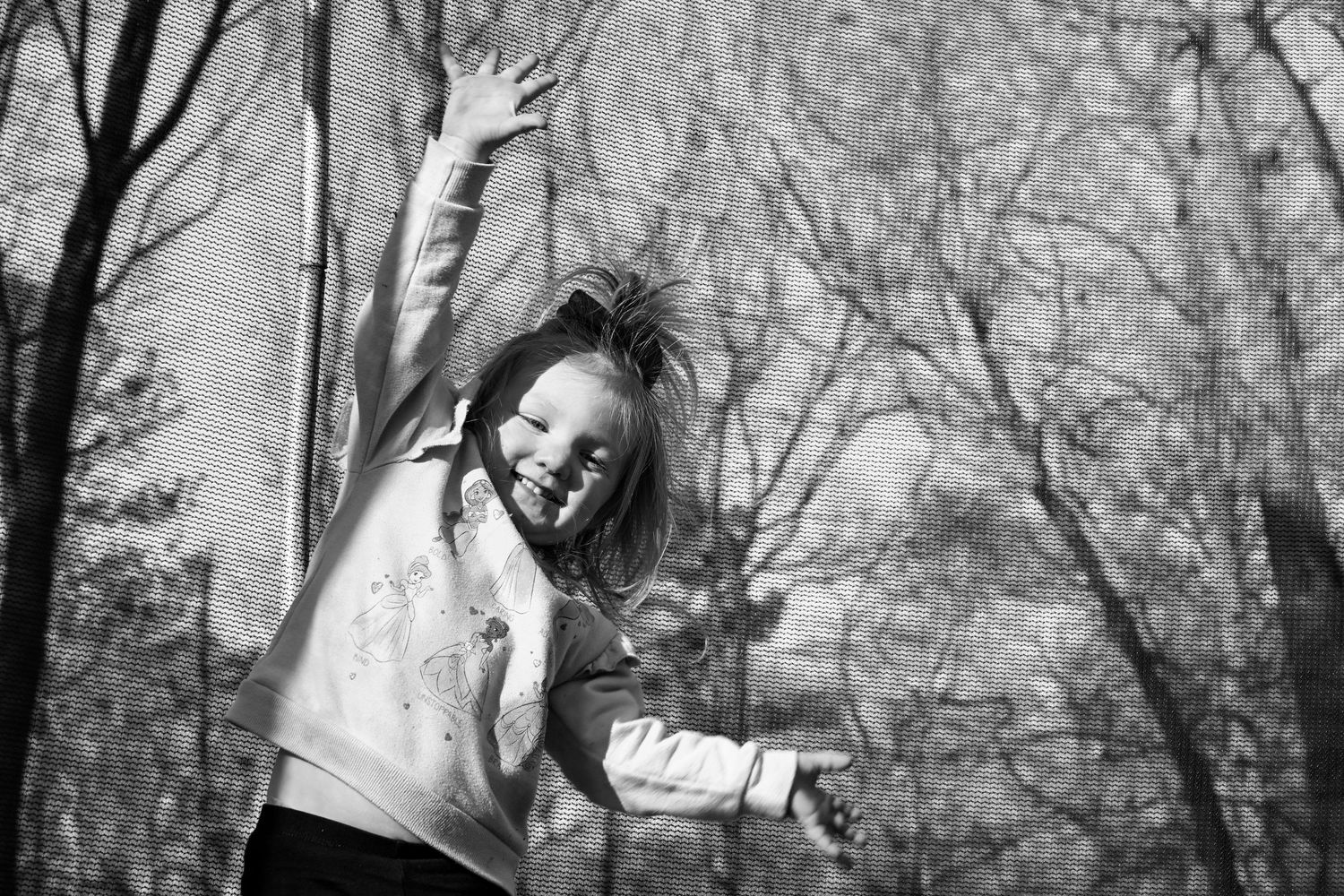Young child on trampoline.