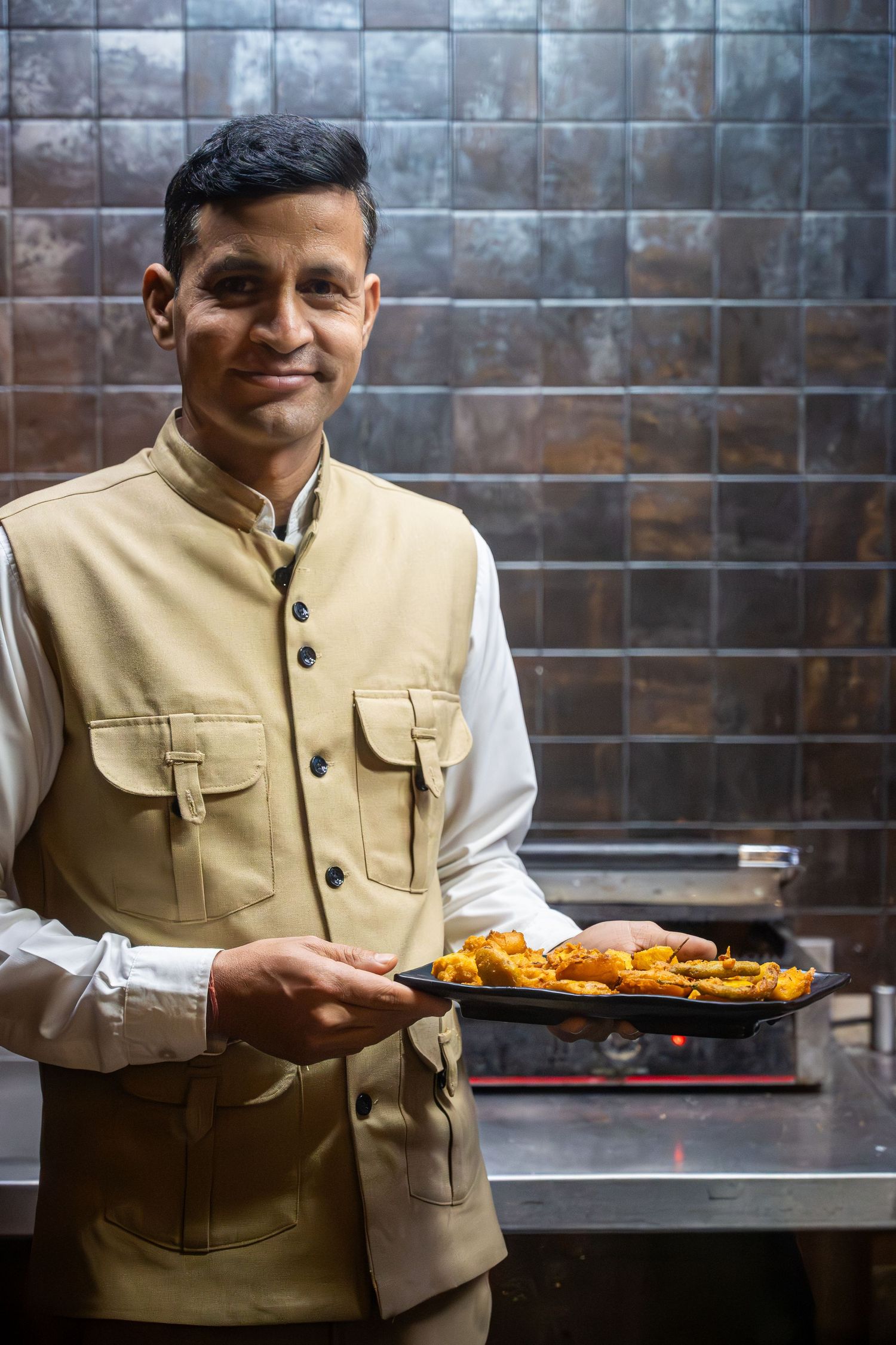 Portrait of a chef in a restaurant in India.