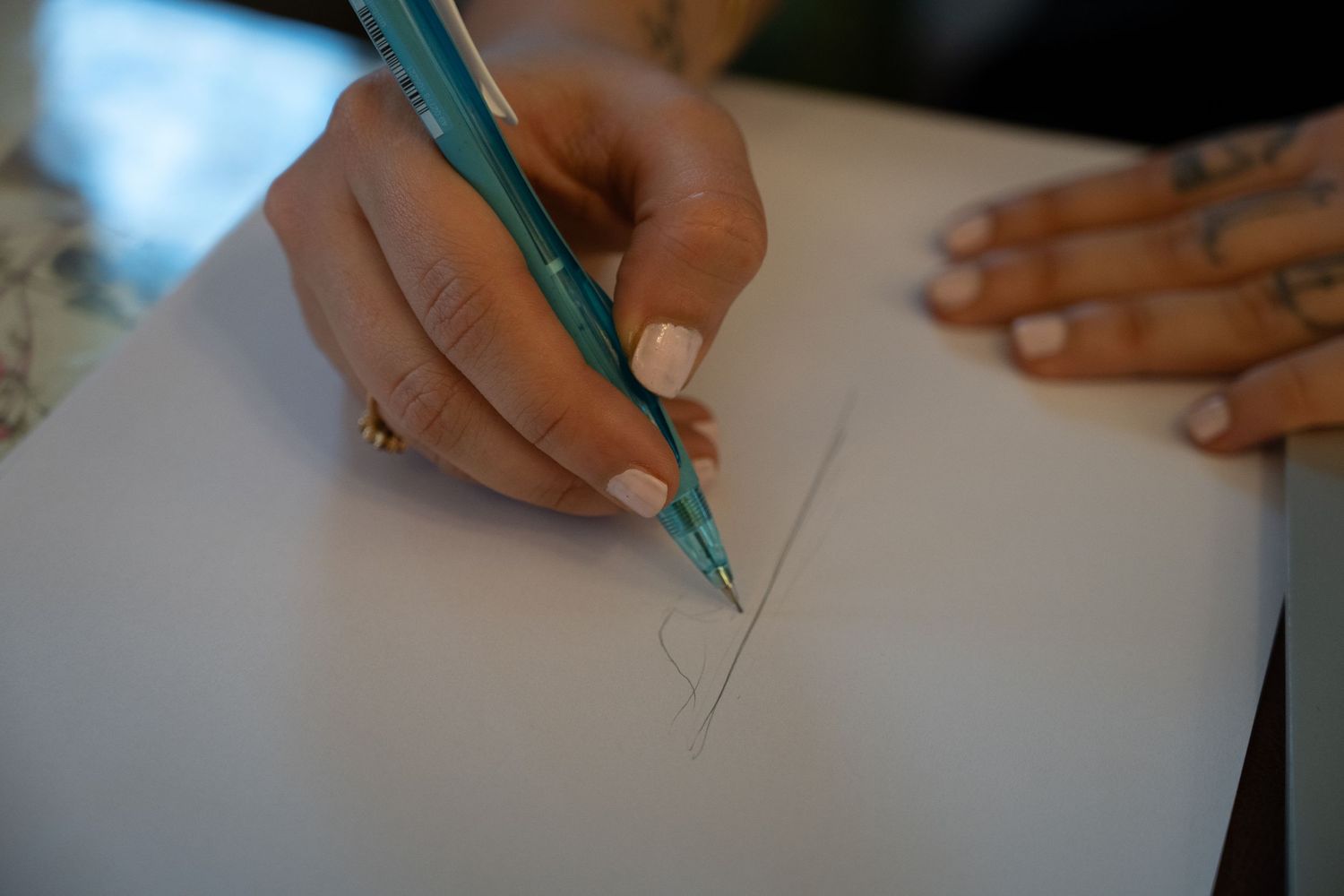 Tattoo artist makes a rough sketch during a consultation in Delhi, India.