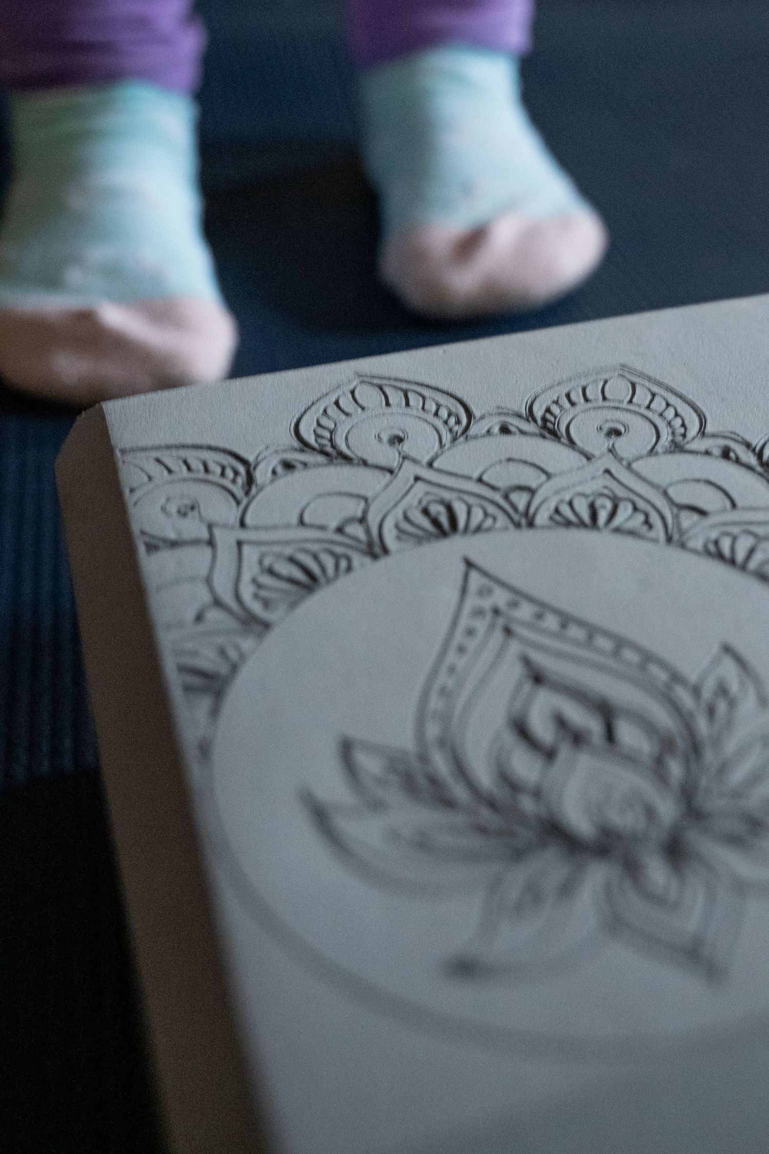 Feet of young child with yoga block.