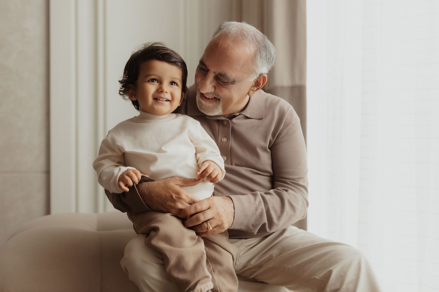 A parent and child share tender moments together in a series of warm, neutral-toned photographs.
