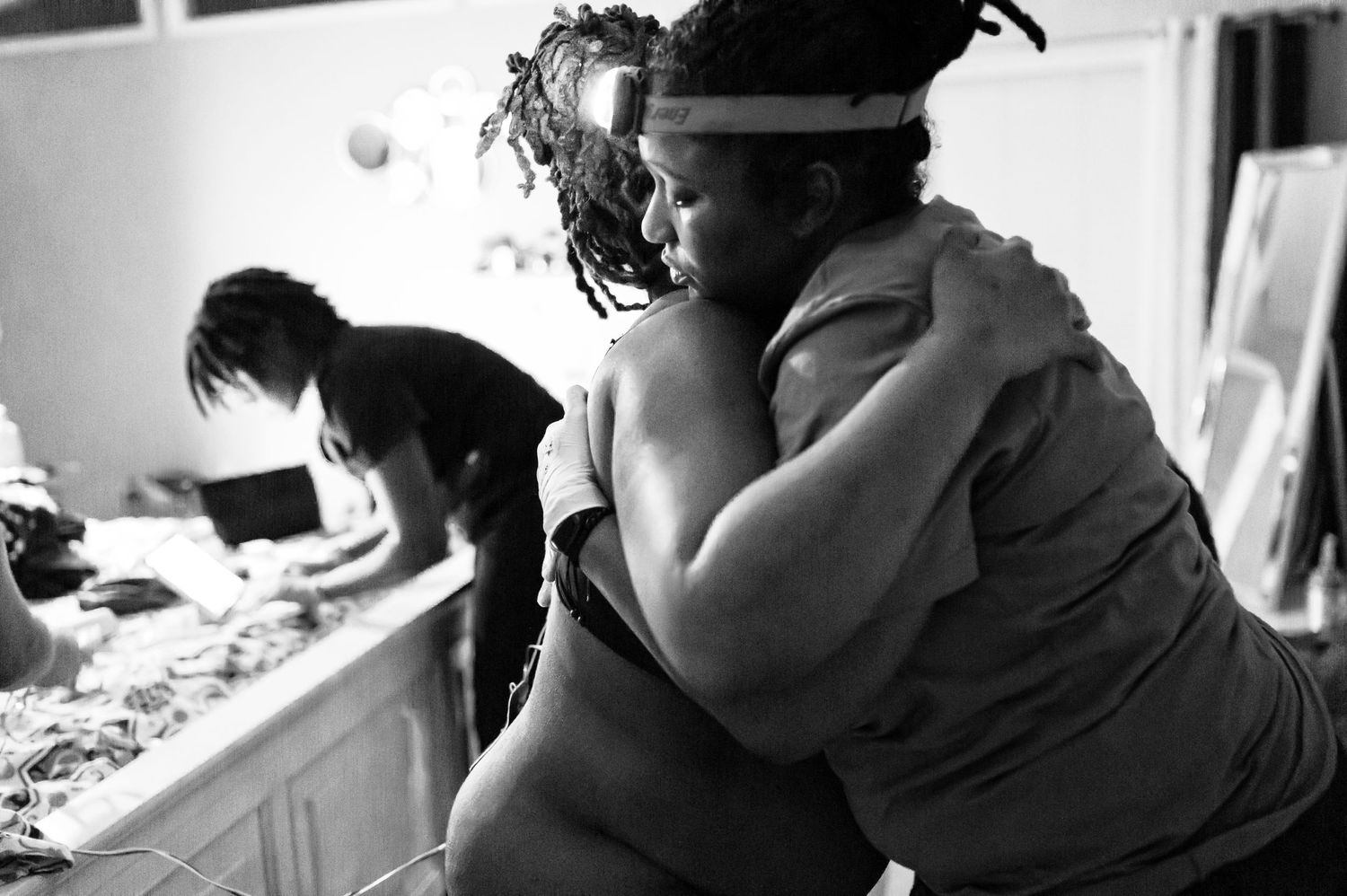 Black and white photo showing emotional support during labor contractions.