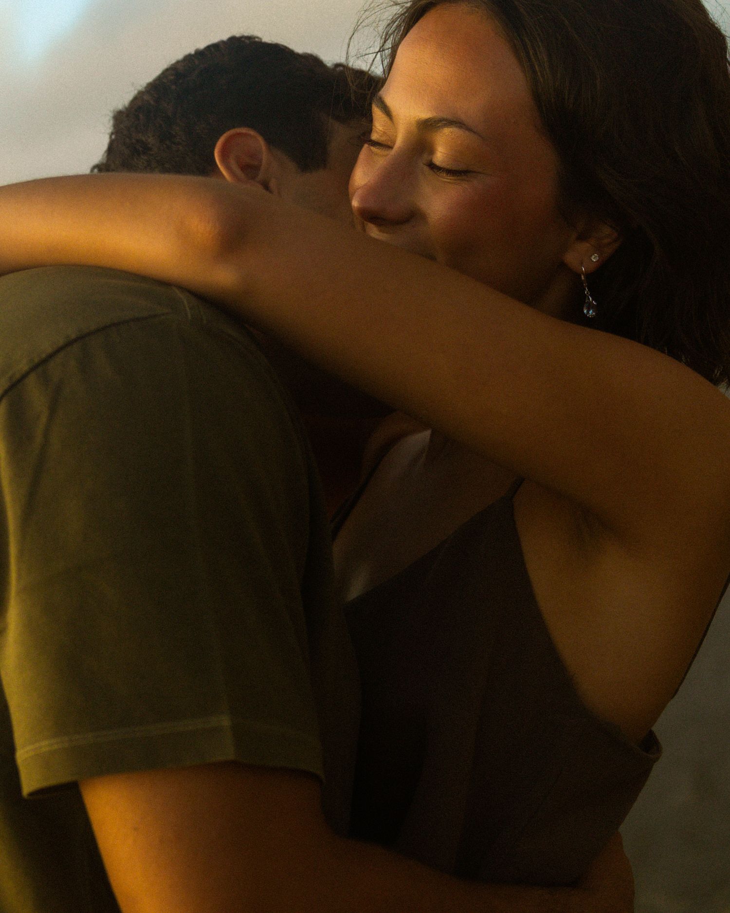 A sequence of intimate silhouettes showing a couple embracing and kissing in warm ambient lighting.