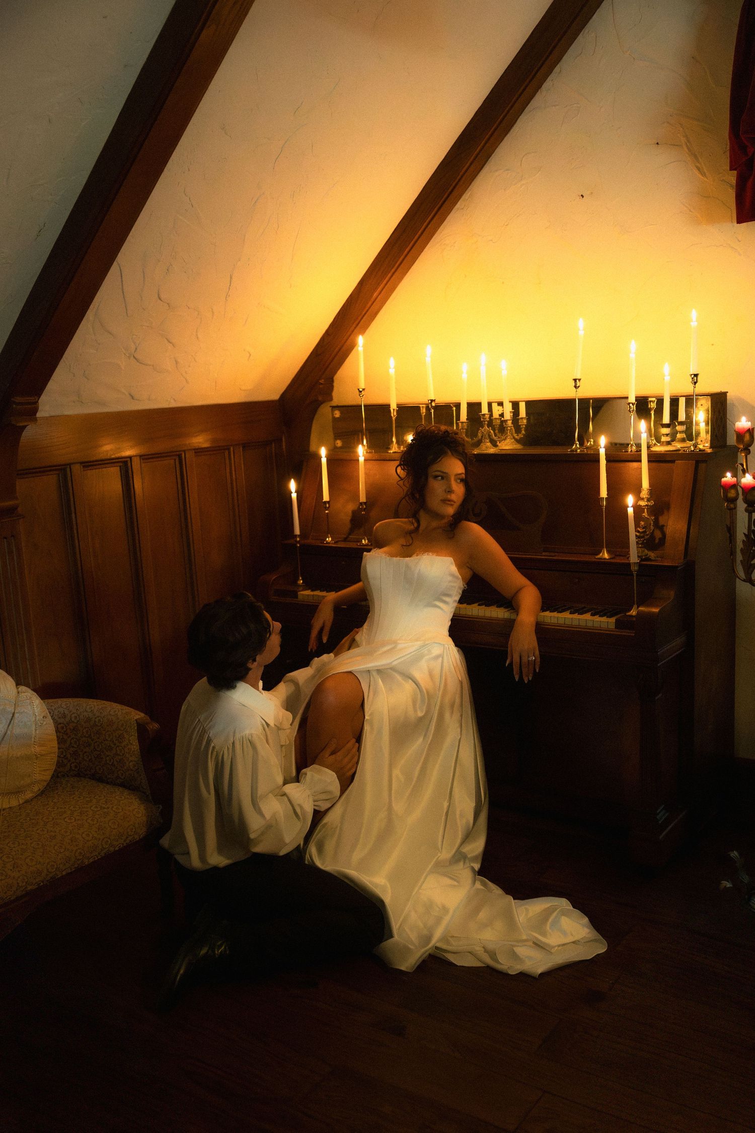 Moody sequence of photos featuring someone in a white gown posing dramatically in a dark wood-paneled room with candles.