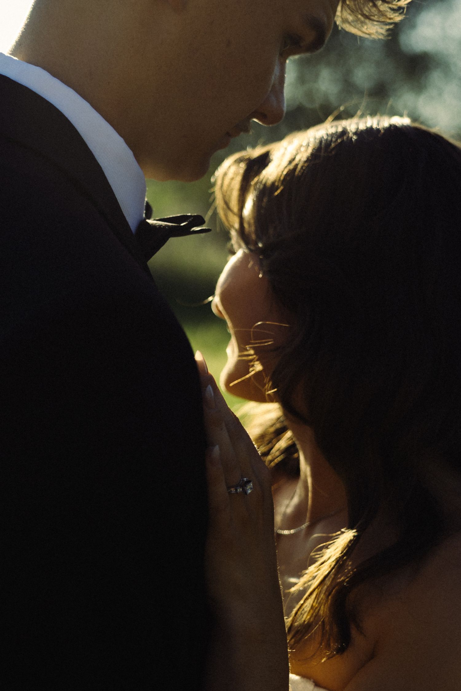 Silhouetted profile of a couple in golden sunlight creating a romantic backlit effect.