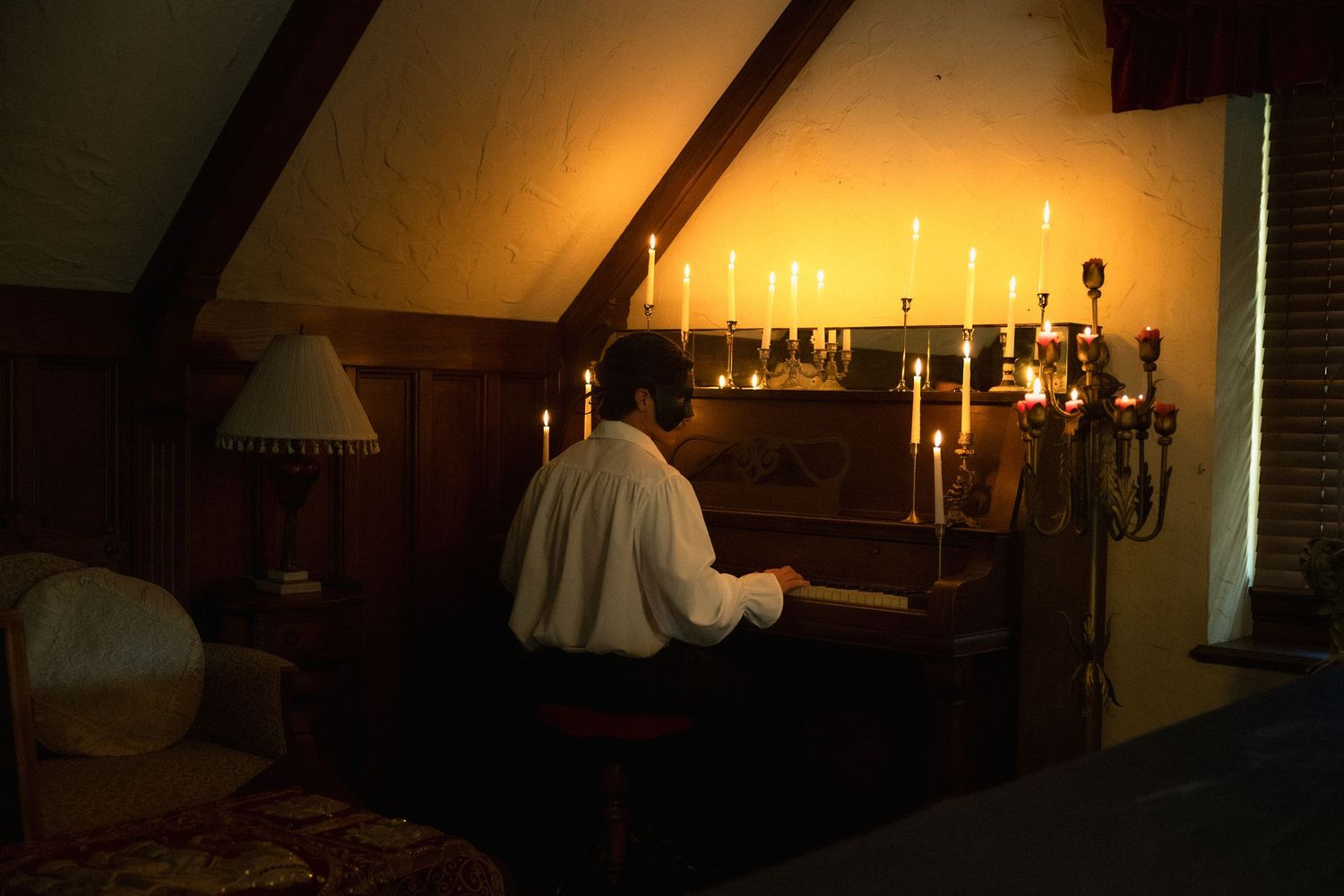 Candlelit interior of a rustic wooden cabin with warm glowing lights creating a cozy ambiance.