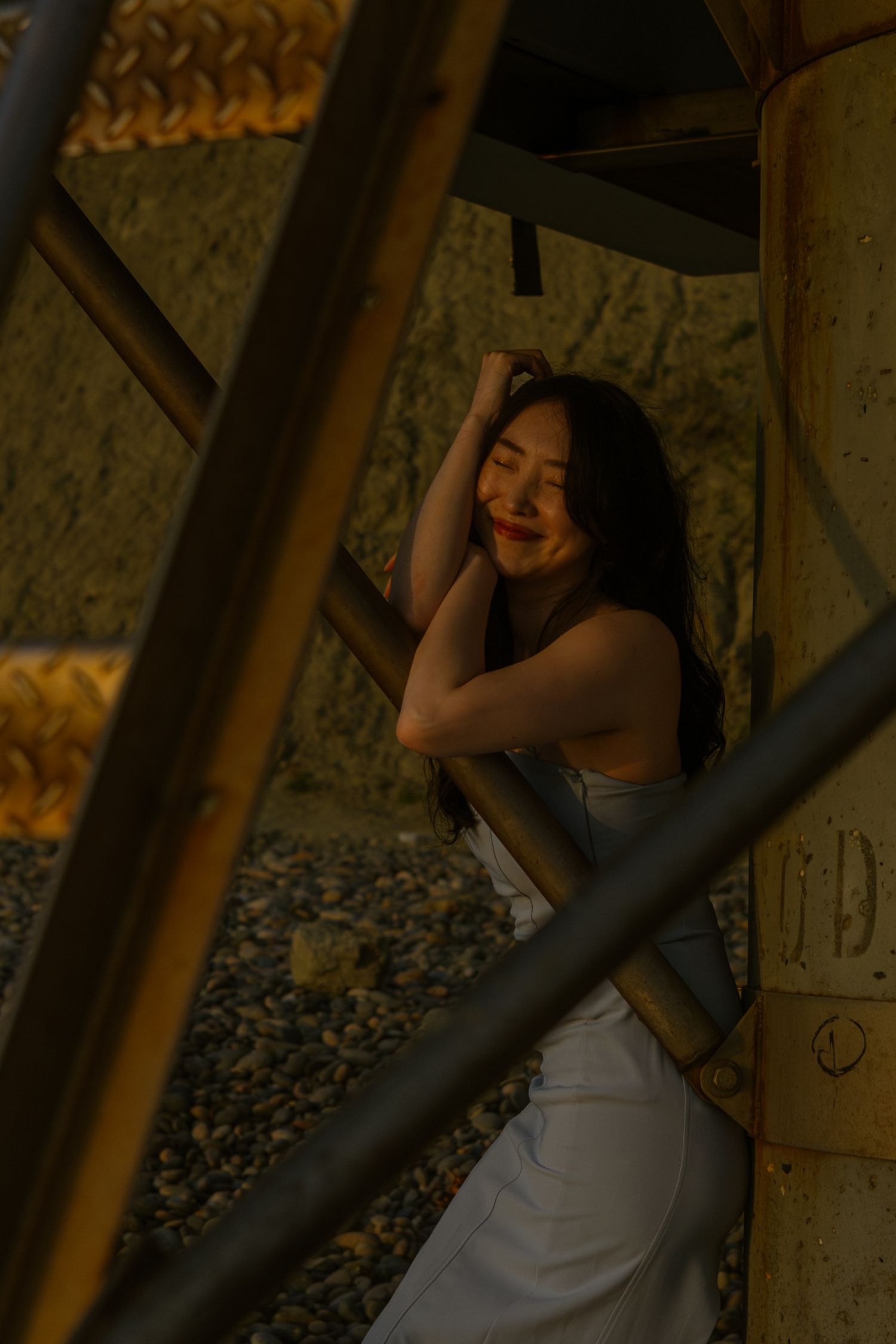 Artistic portraits captured in warm lighting against textured architectural elements.