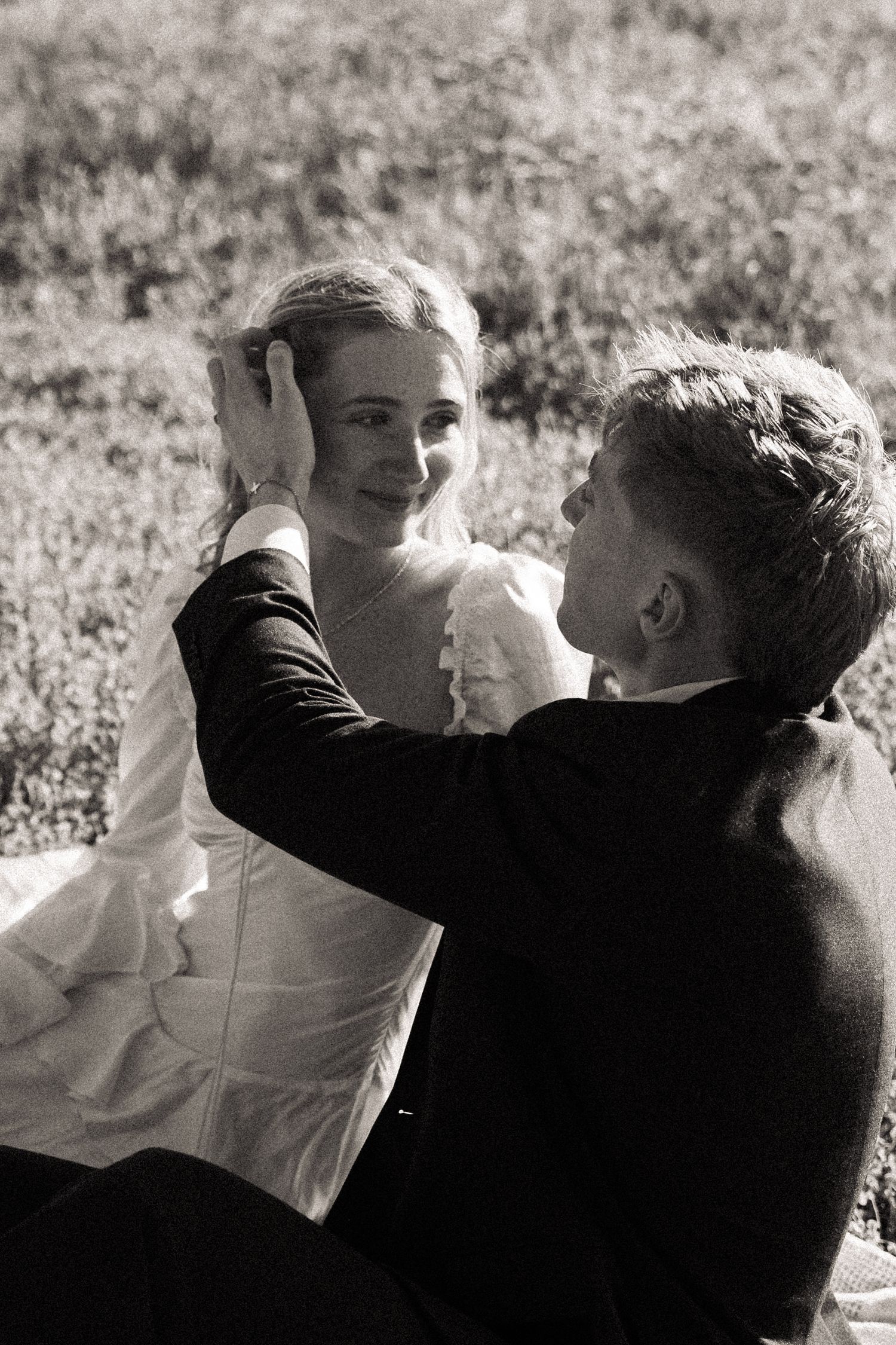 A black and white sequence shows a tender romantic moment between a couple in formal attire.