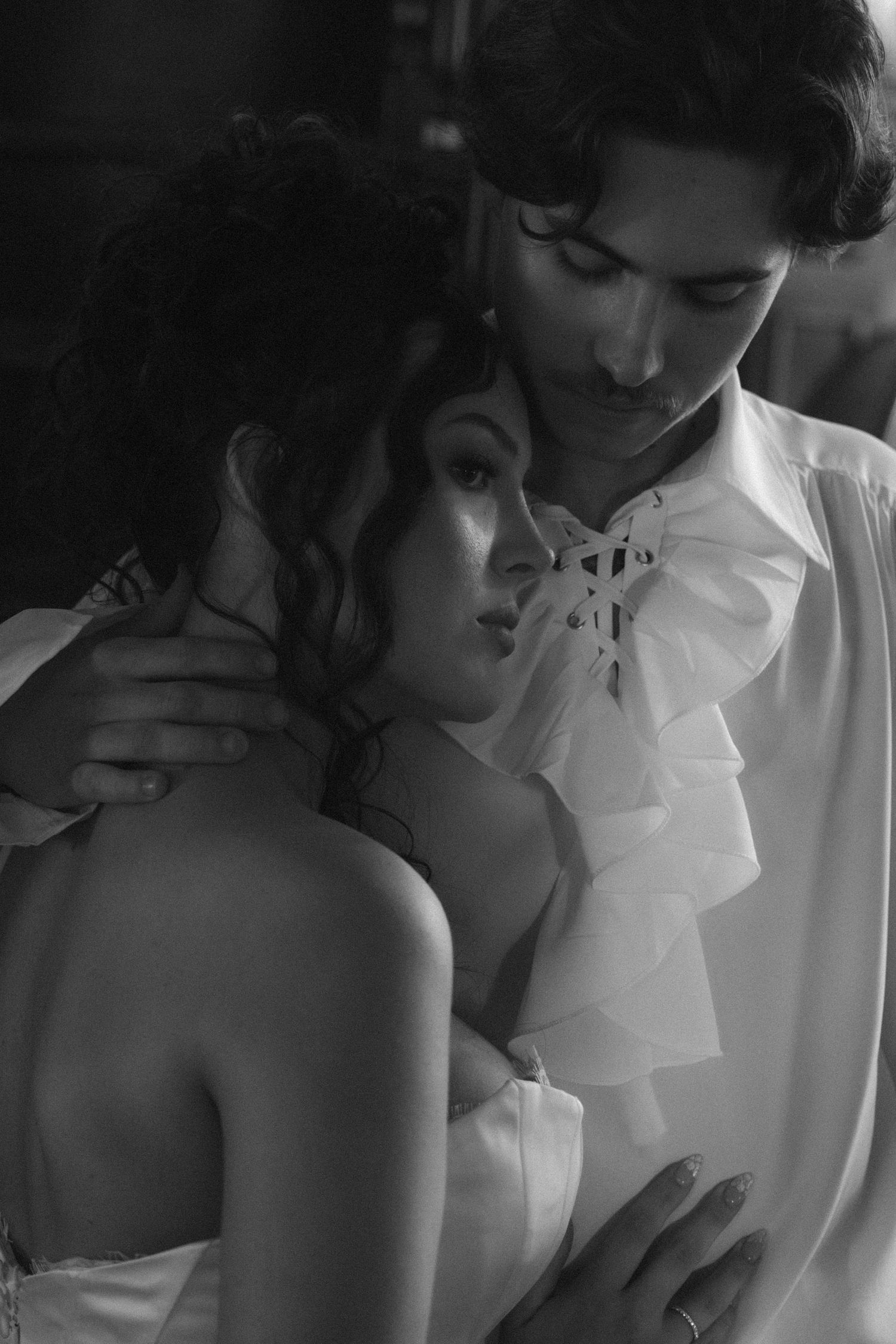 Intimate black and white portrait sequence capturing tender moments in soft, natural lighting.