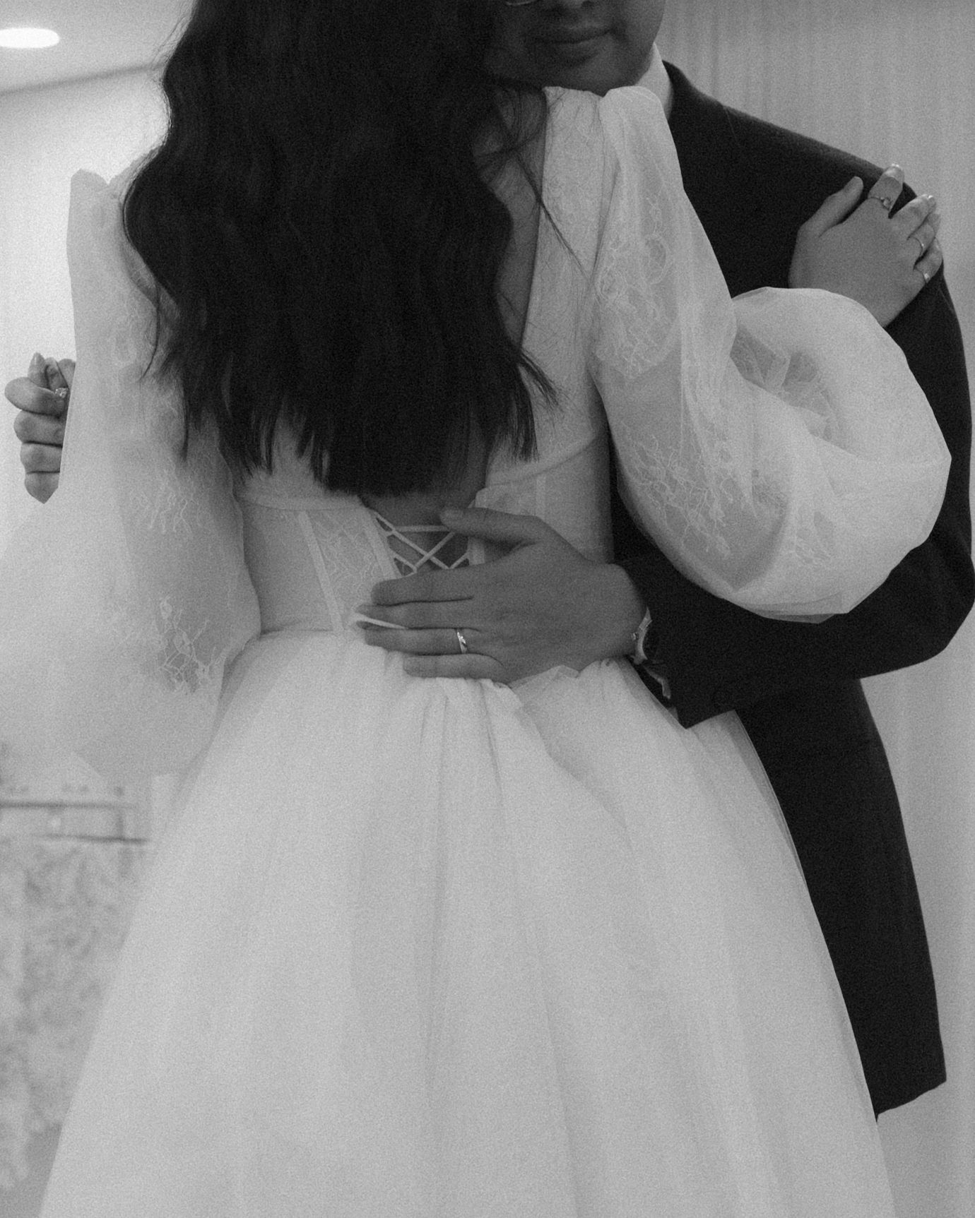 A series of black and white wedding photos showing couples embracing and dancing in formal attire.