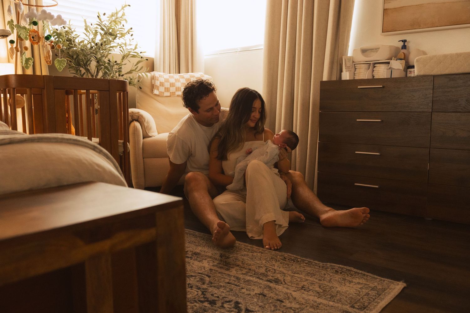 A couple moves furniture and boxes into their new home during a daytime relocation.