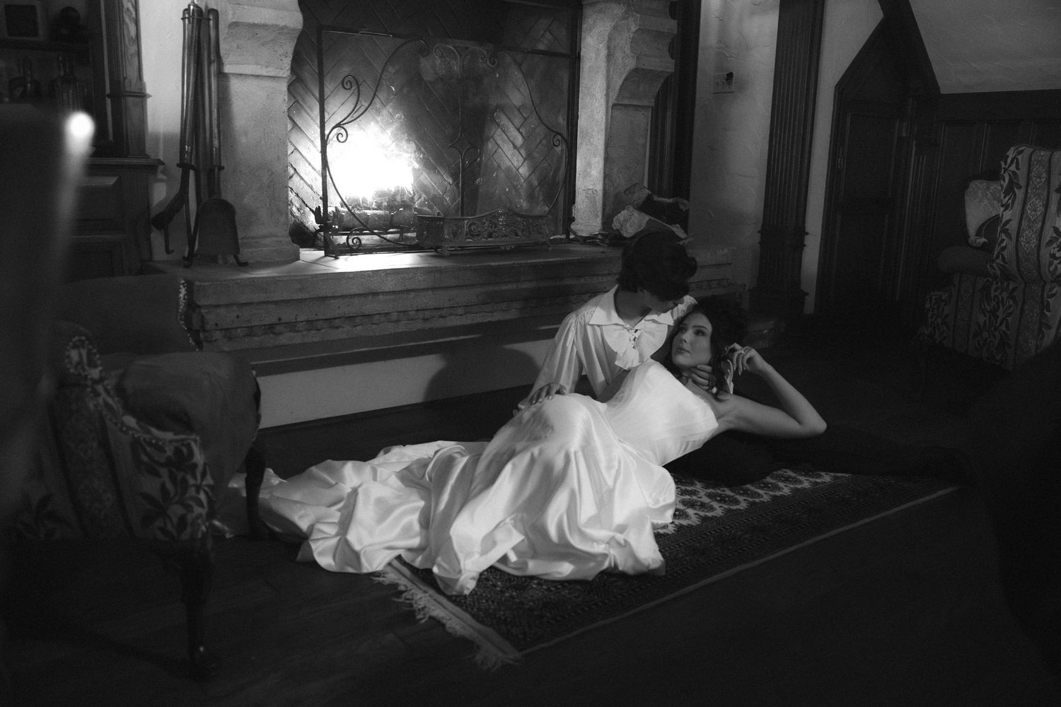 A dramatic black and white series of photos showing someone resting on a couch in different poses.
