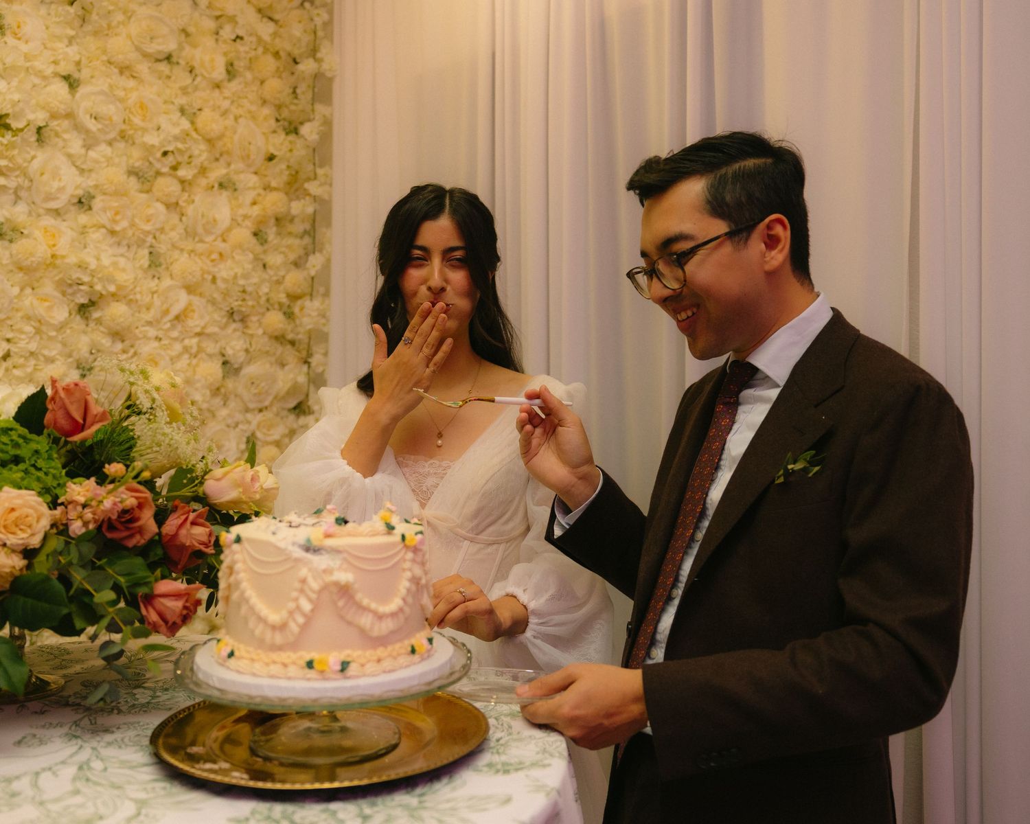 Wedding reception scene with elegant table settings and guests enjoying the celebration.
