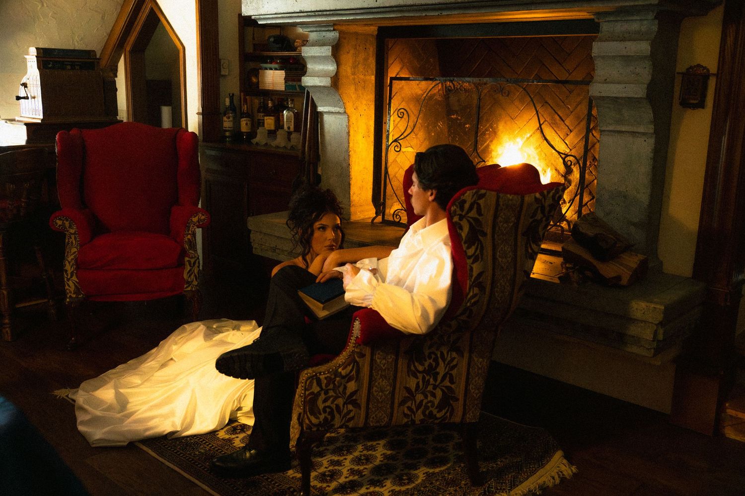 Warm-toned interior photos showing fireplace and vintage furniture in romantic evening lighting.