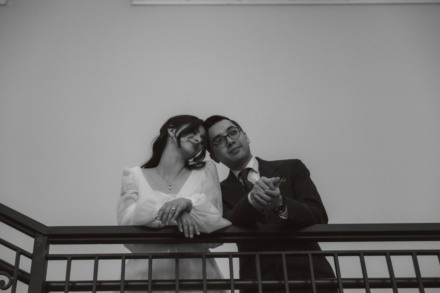 A black and white photo montage showing multiple candid moments of people on a balcony or railing.