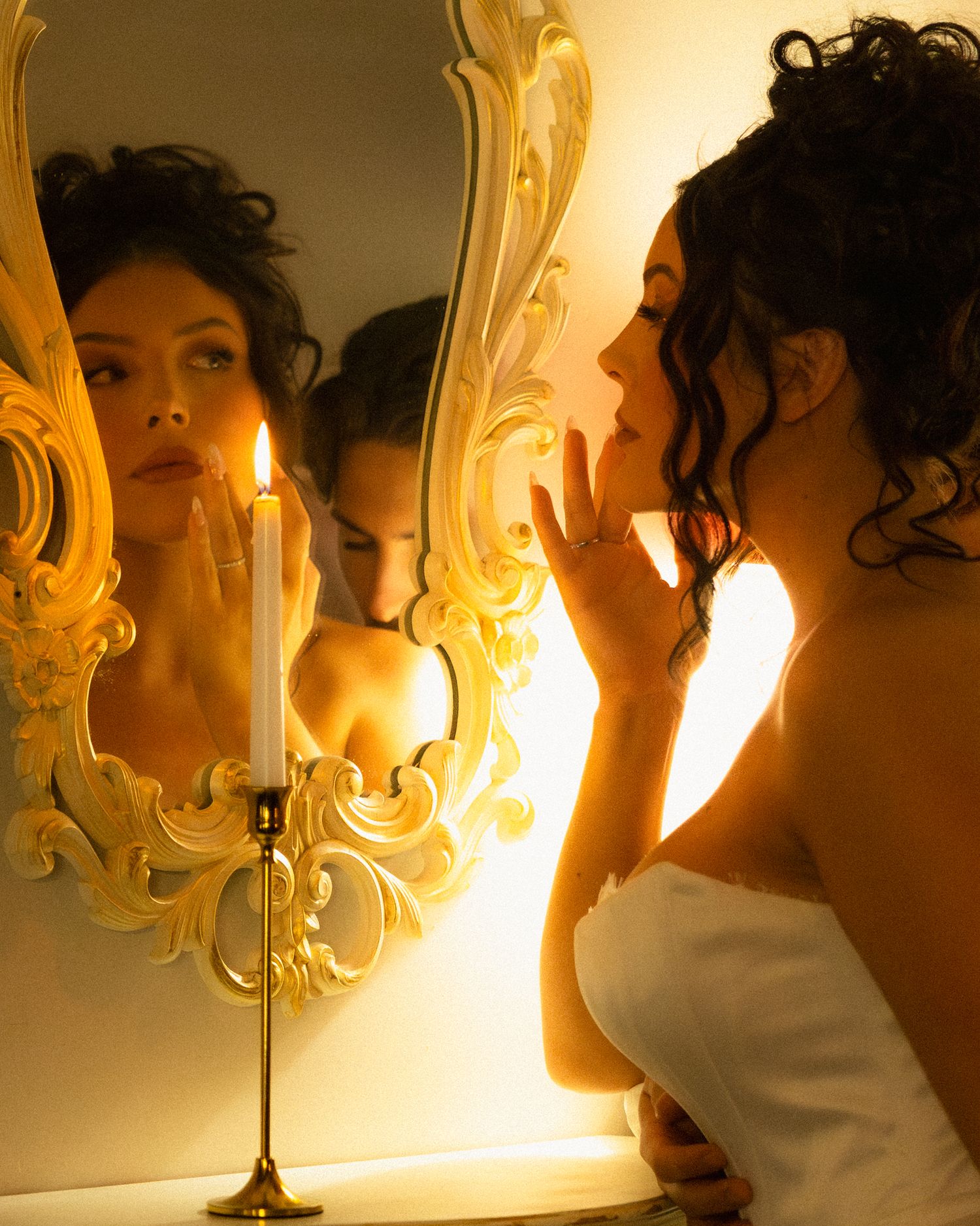 A series of five artistic photos showing a figure illuminated by warm candlelight next to an ornate mirror.