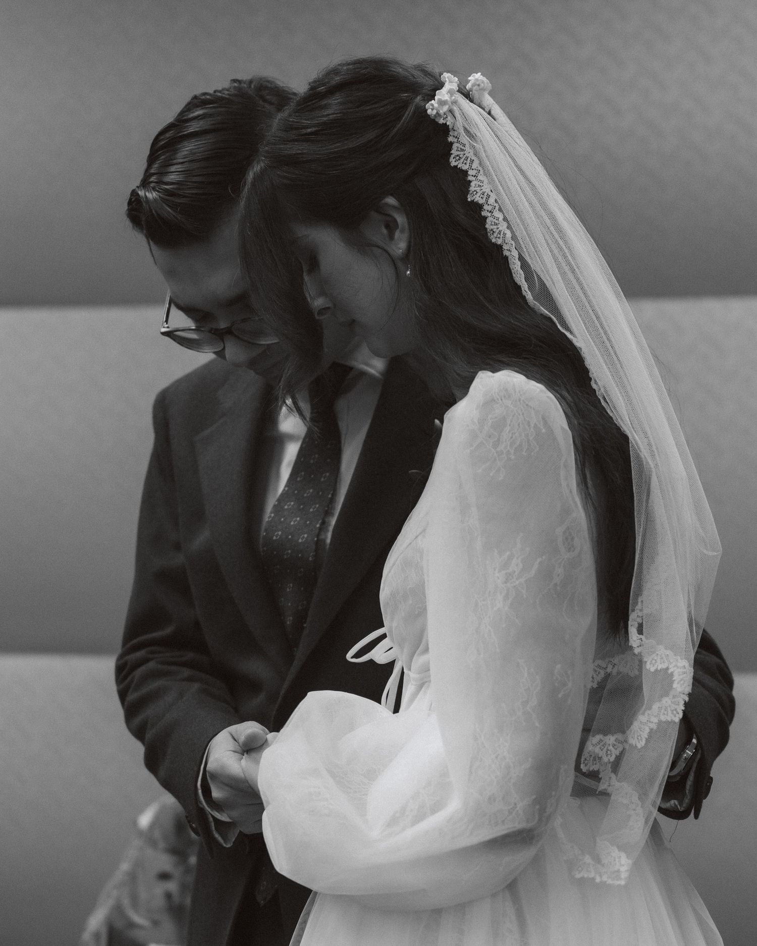 A series of romantic black and white photos showing tender moments between a bride and groom during their wedding ceremony.