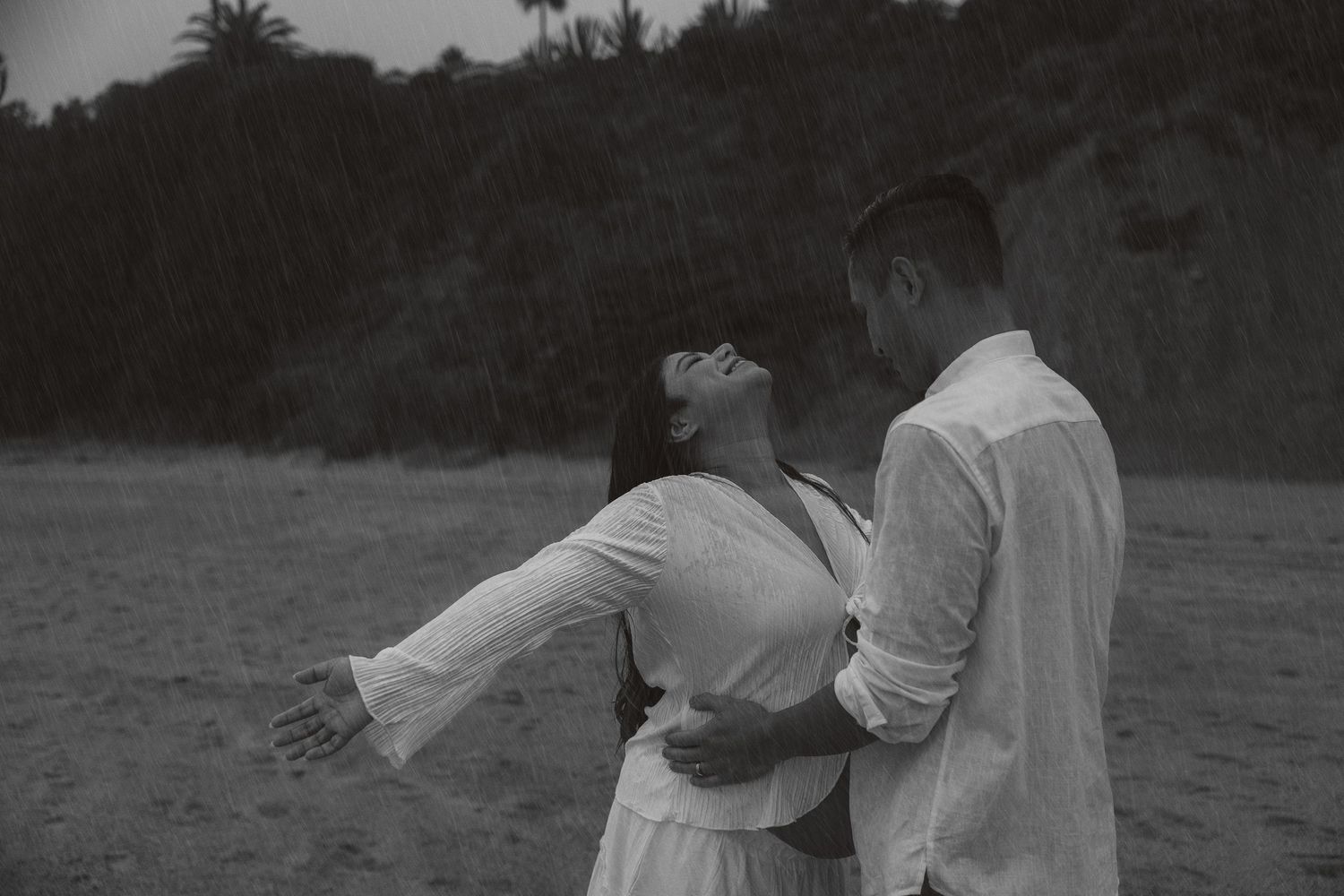 Black and white photo sequence showing a couple dancing together on a beach with graceful movements and spins.