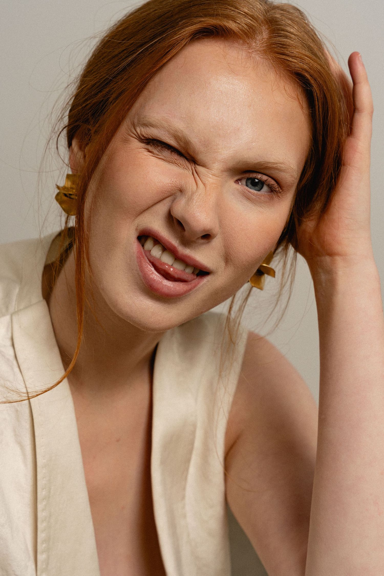 A series of expressive portrait shots showing playful poses against a light neutral background.