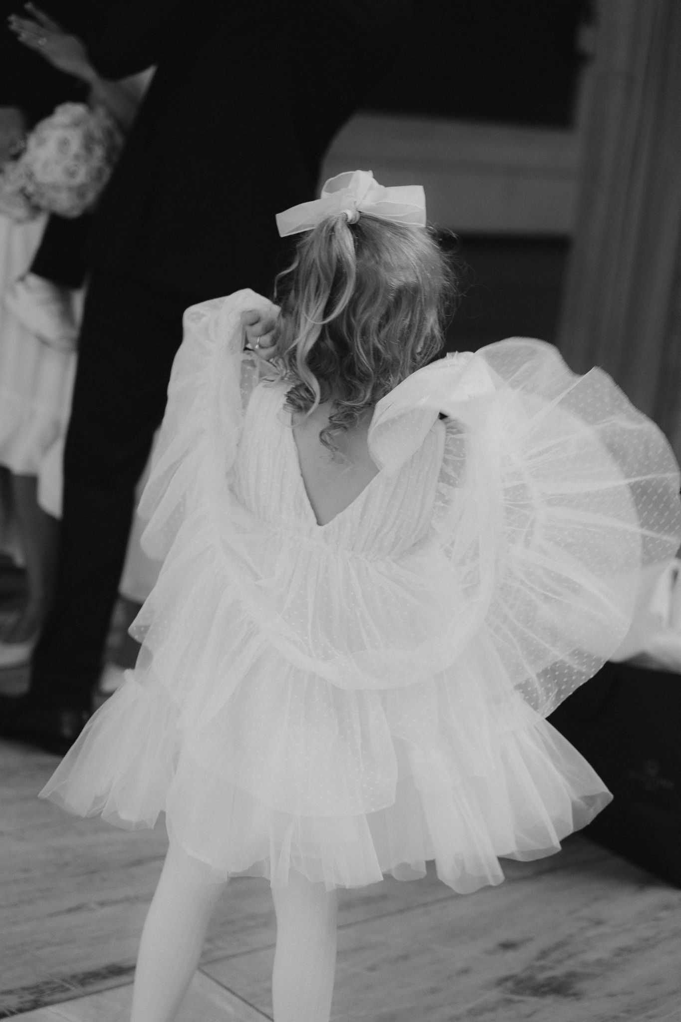 Black and white photo series showing the flowing movement of a white tulle dress against a dark background.