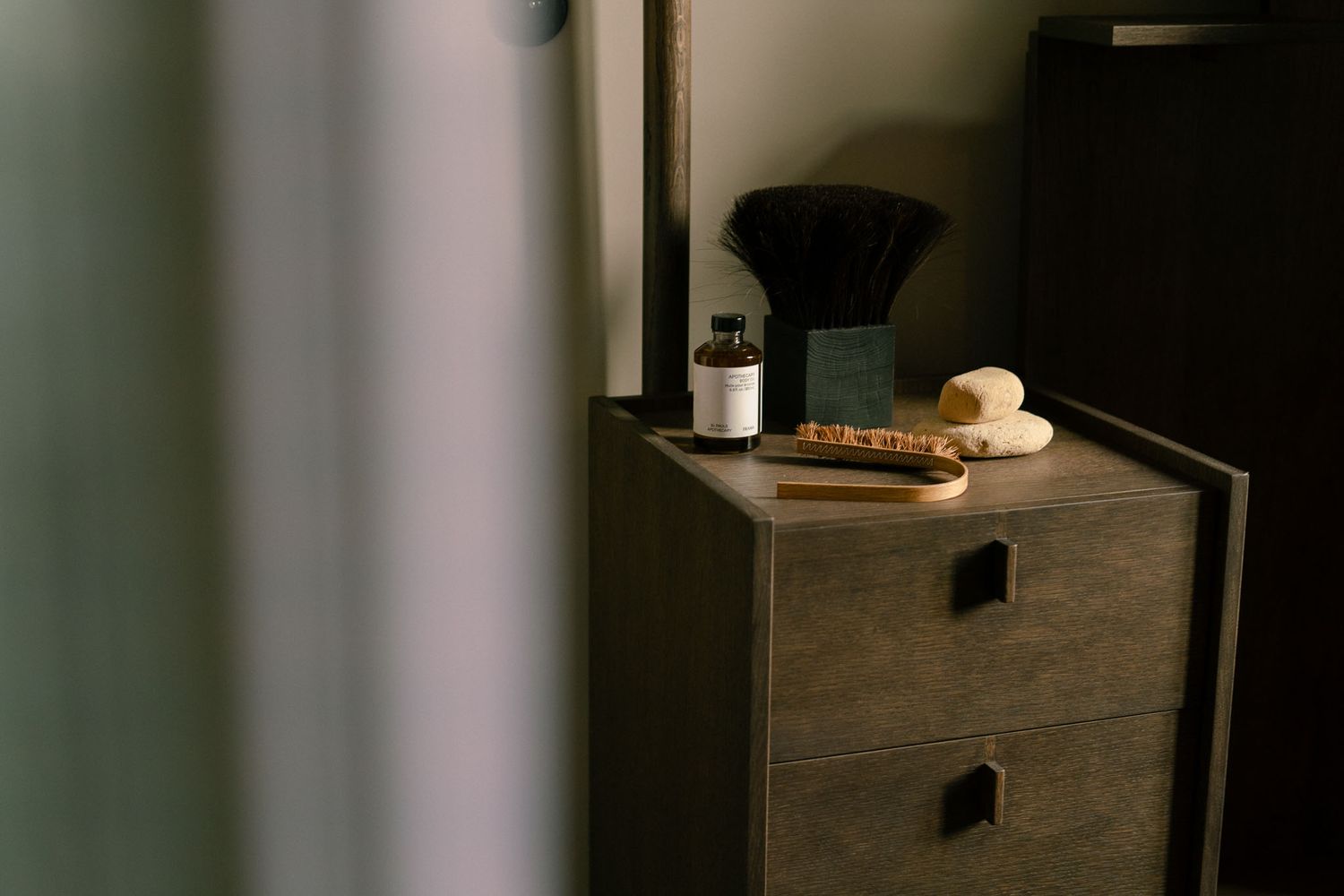 Wooden dresser with coffee brewing equipment and morning light creating a cozy coffee corner setup.