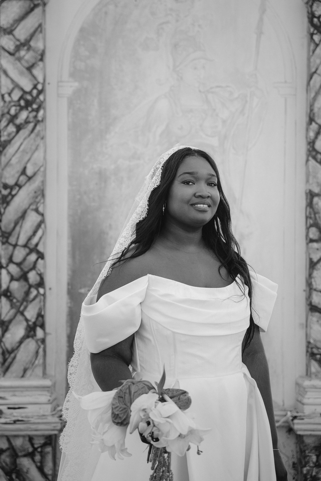 A series of black and white bridal portraits showing a person in an elegant off-shoulder white dress against a textured wall.