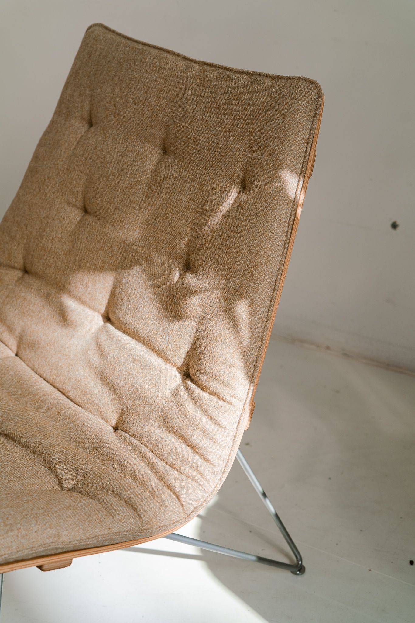 Modern beige tufted chair with chrome legs shown from multiple angles in natural lighting.