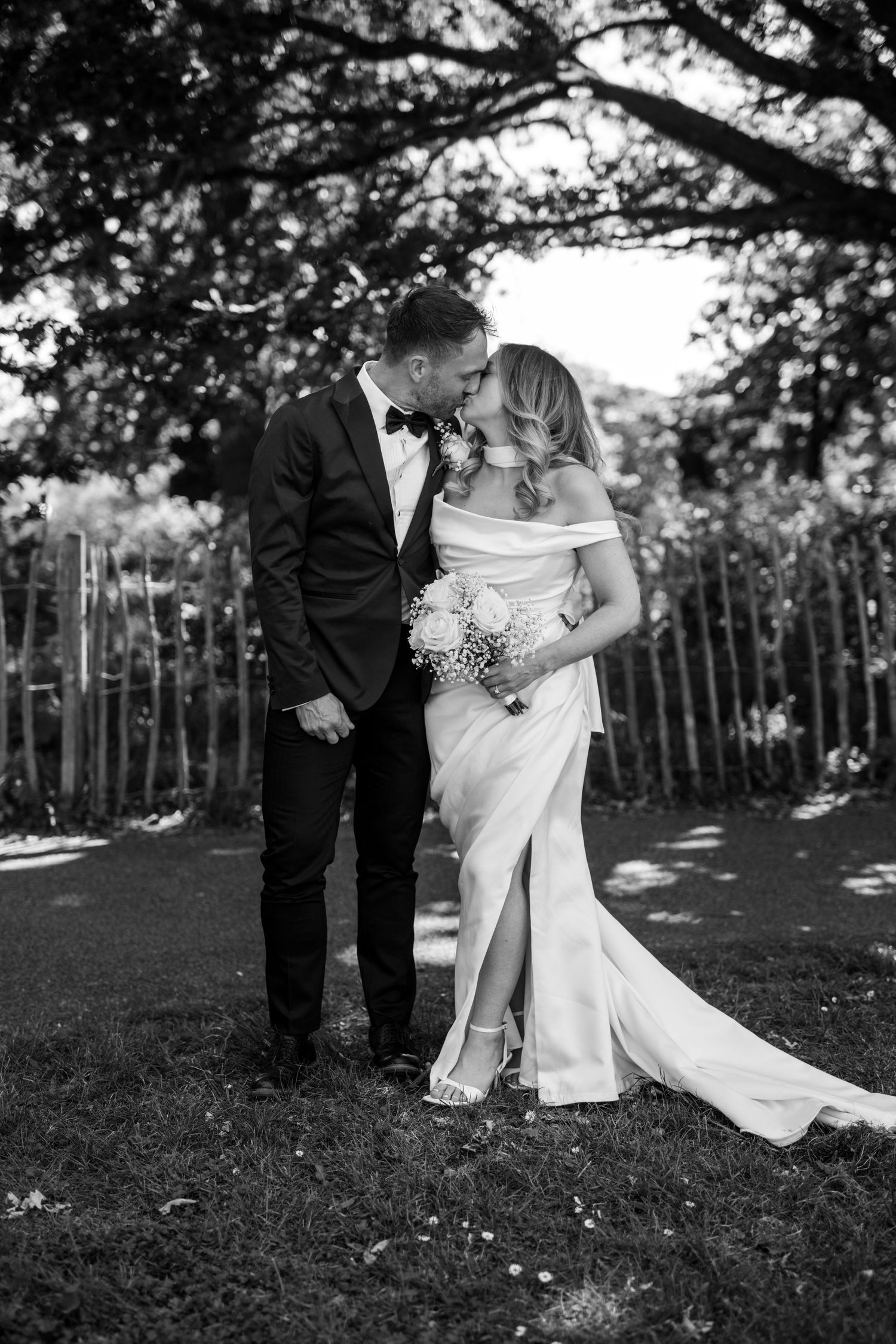 A romantic black and white photo series showing a couple dancing together in an outdoor garden setting.