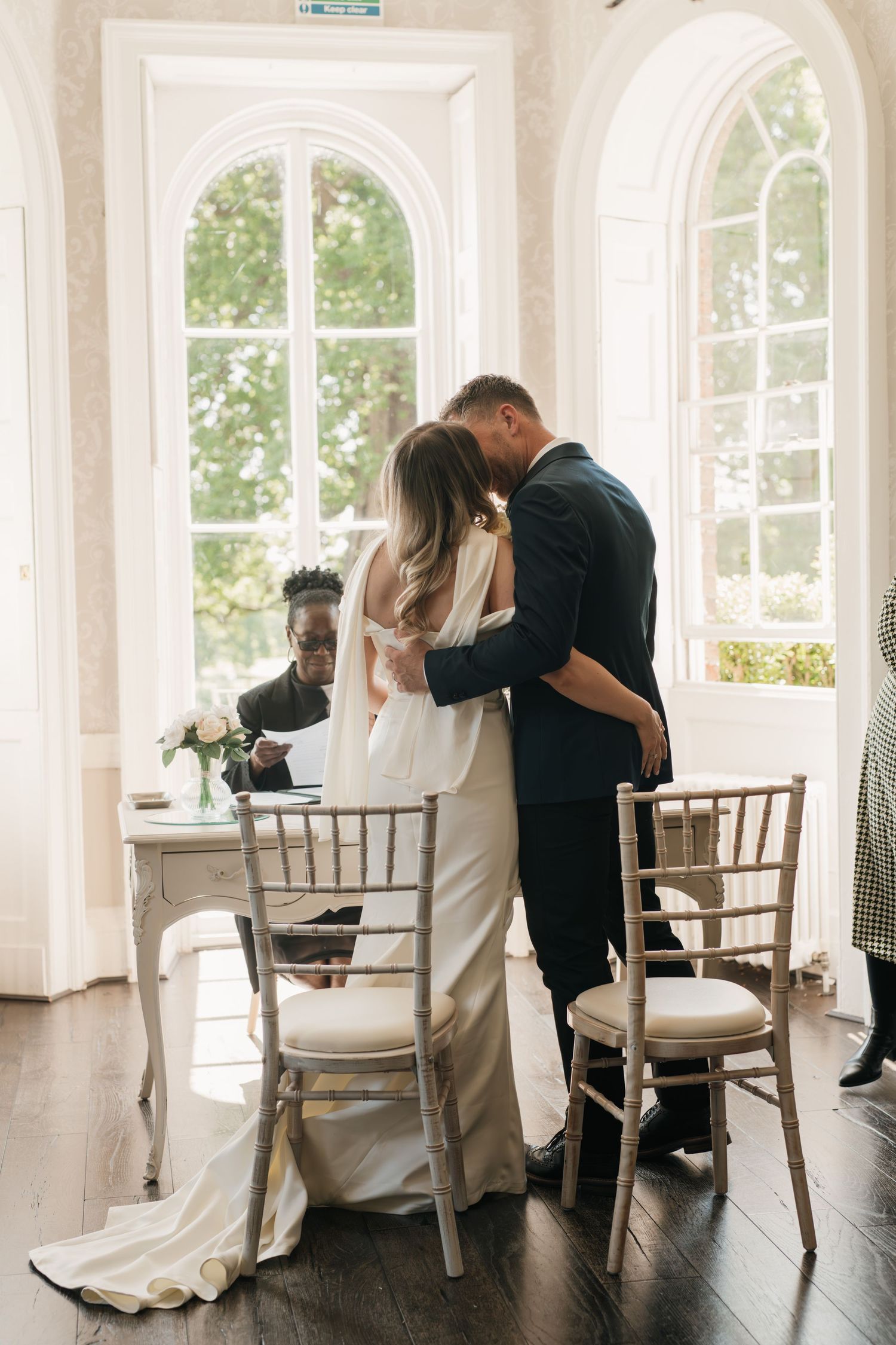 Elegant wedding photography sequence showing intimate dance poses in a bright sunlit room with white walls and windows.