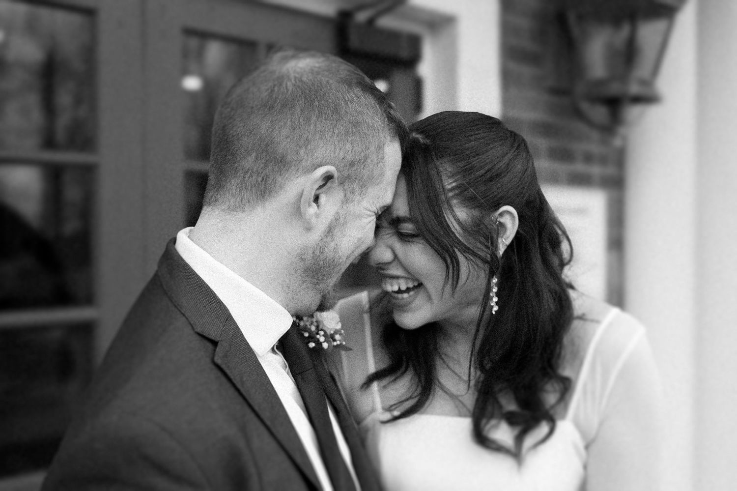 Black and white wedding portraits showing tender moments between newlyweds.