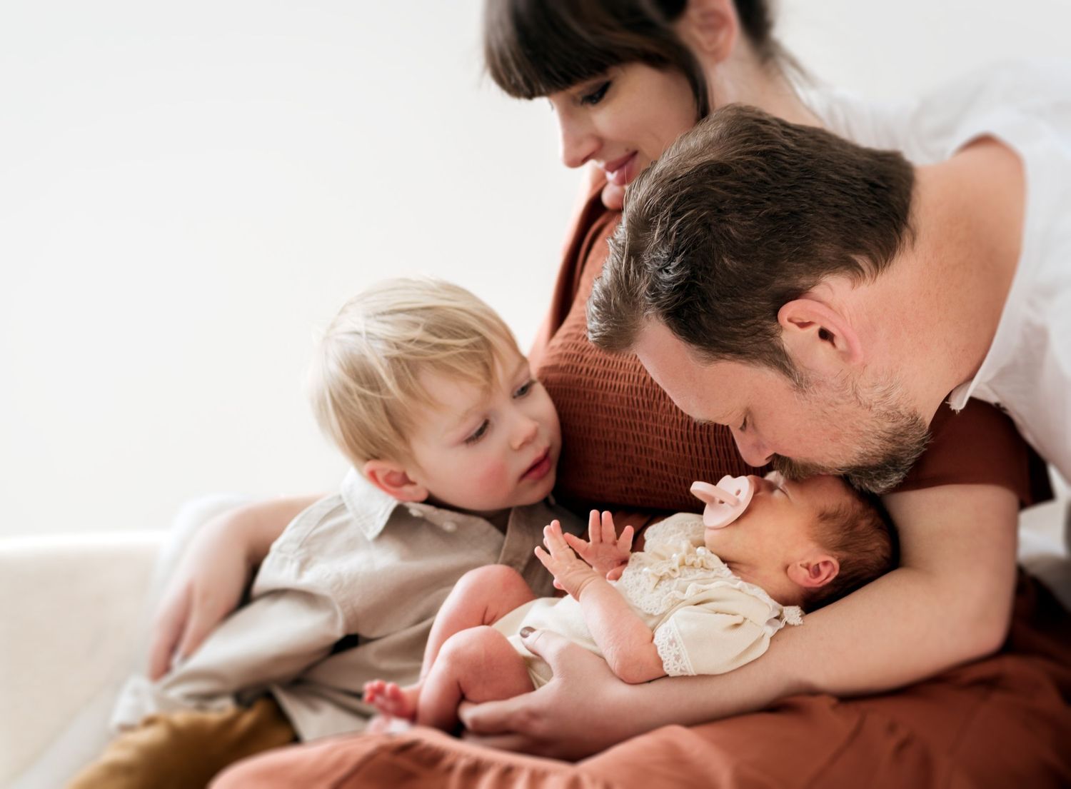 Intimate family moment captured in warm lighting during lifestyle photography session.