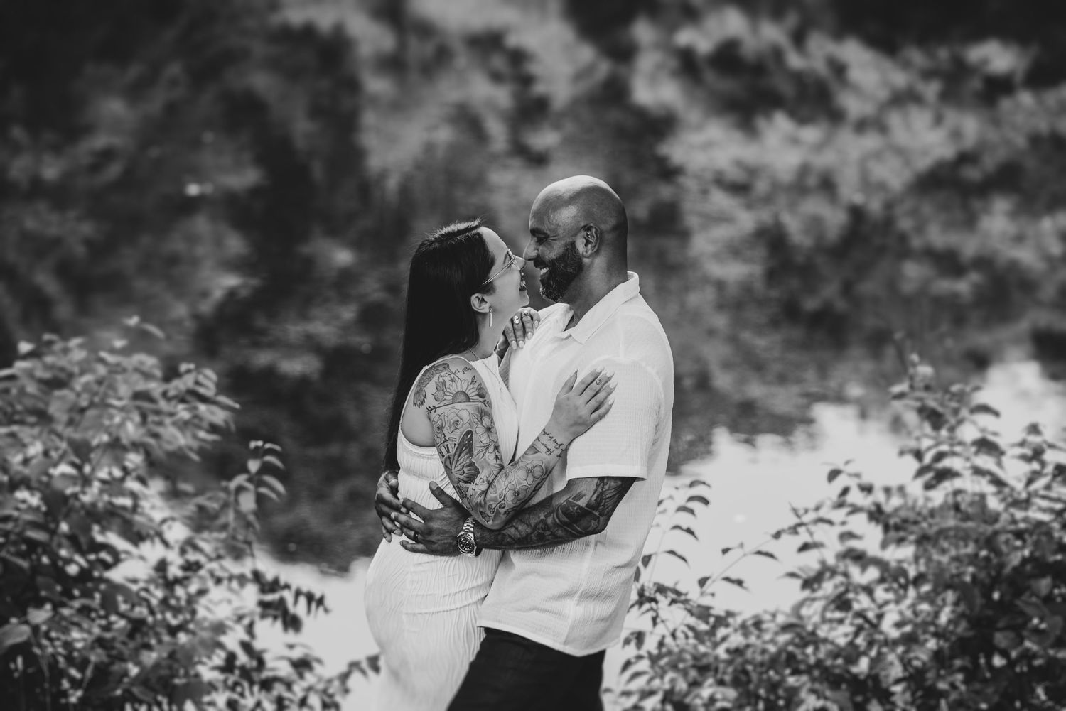 Artistic black and white couples portraits in natural wooded setting.