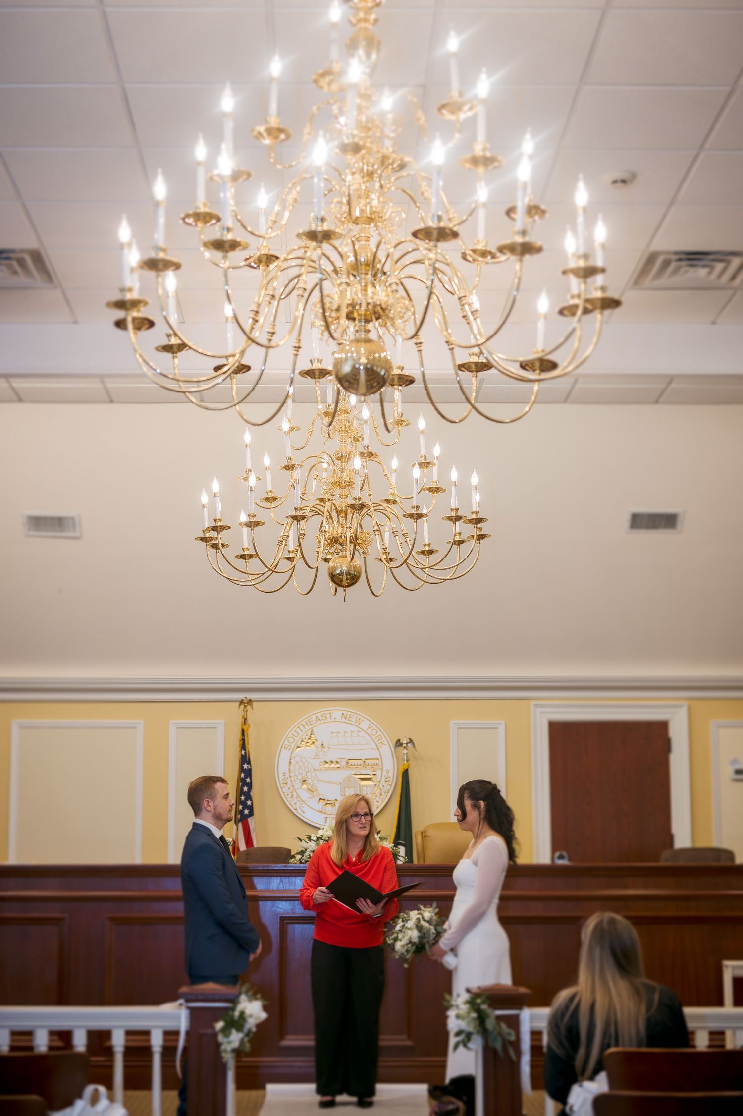 Ornate crystal chandelier illuminating a formal event space.