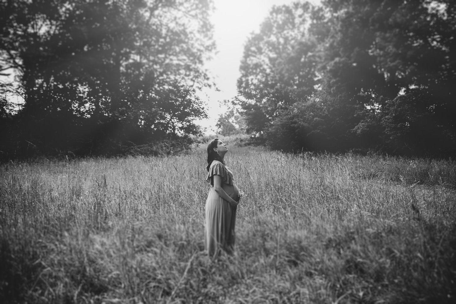 Artistic black and white photos of figure walking through misty field at sunset.